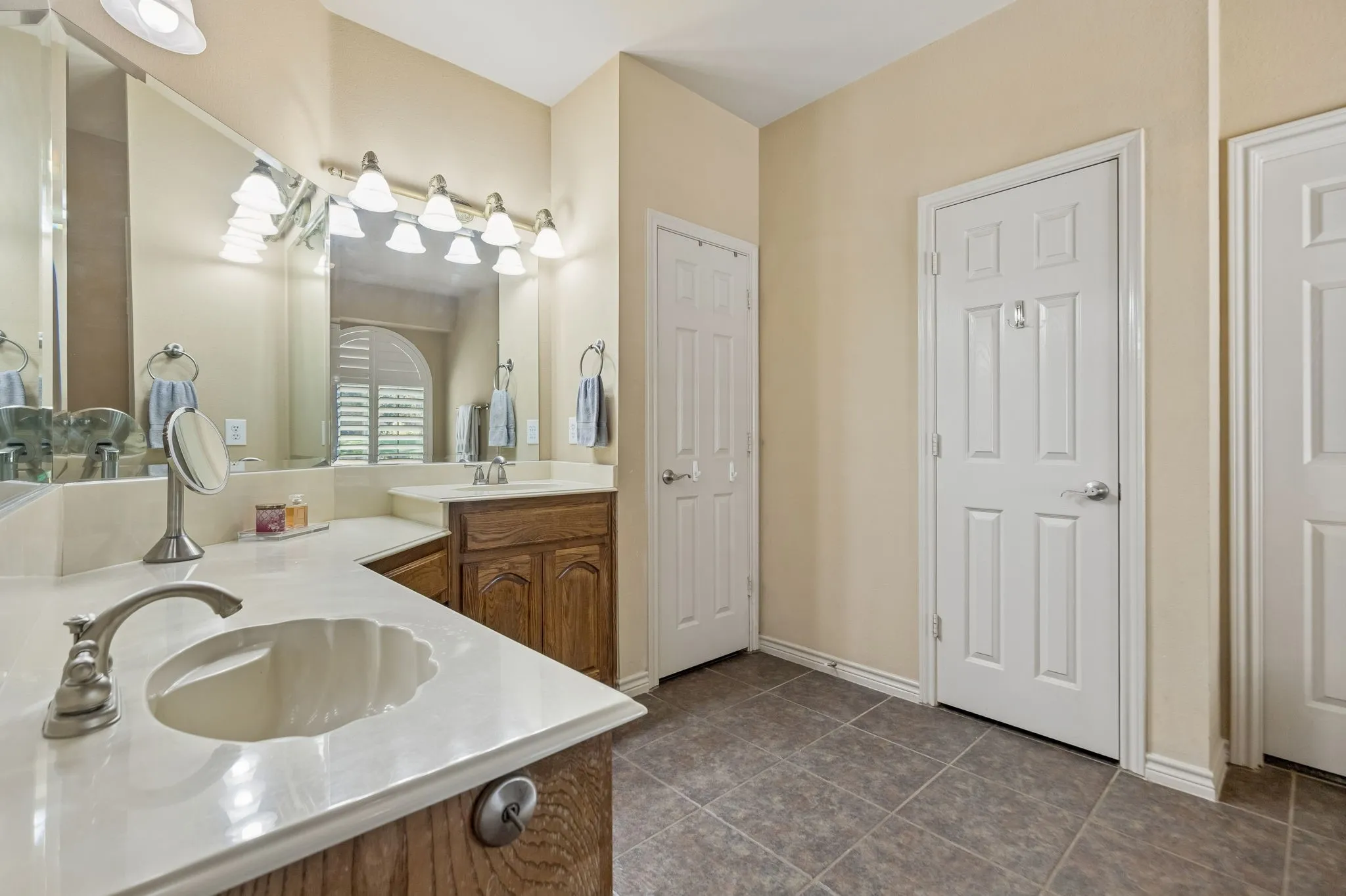 A Bath Designed for Two - Separate vanity areas provide individual space for daily routines while generous countertop storage helps keep the primary bath functional and organized.