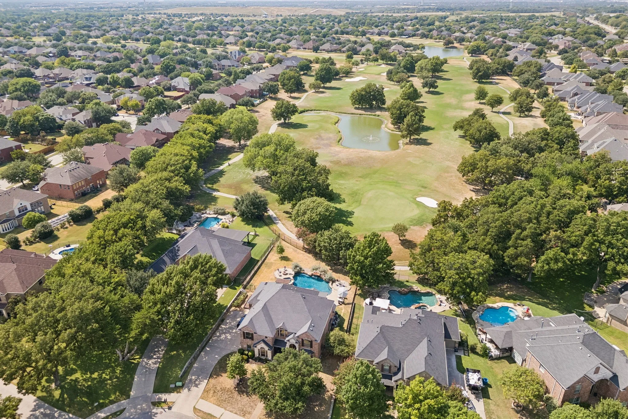 Golf Course Living from Above - This aerial perspective captures the home's exceptional setting along the #4 green of Waterview Golf Course, with the fairway stretching into the distance and showcasing why this over-one-third-acre lot is such a standout within the neighborhood.