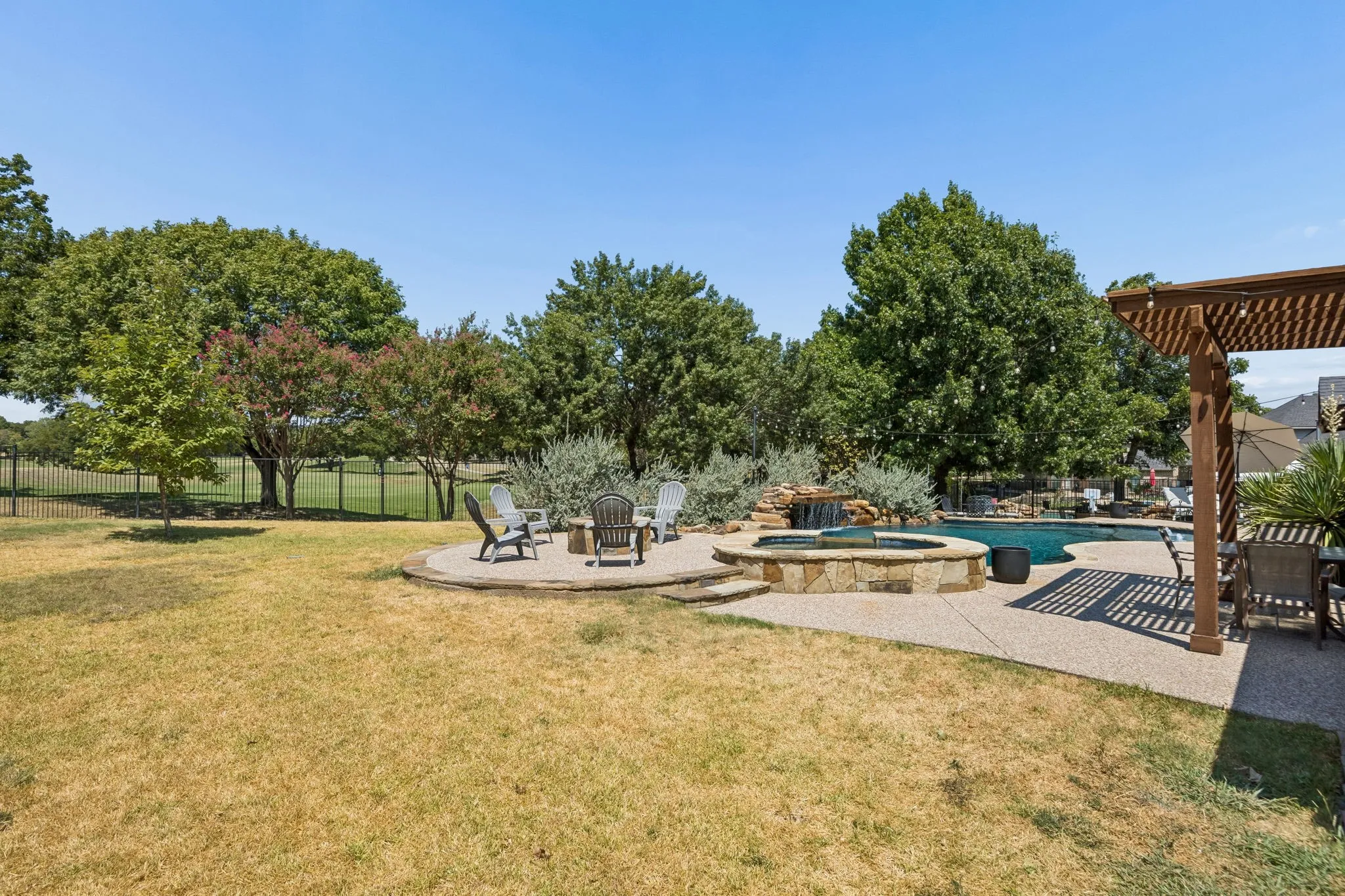 More Than Just a Pool Lot - Even with the pool, spa and outdoor living areas, this over-one-third-acre homesite still offers a substantial lawn and open space, all framed by mature trees and the golf course beyond.