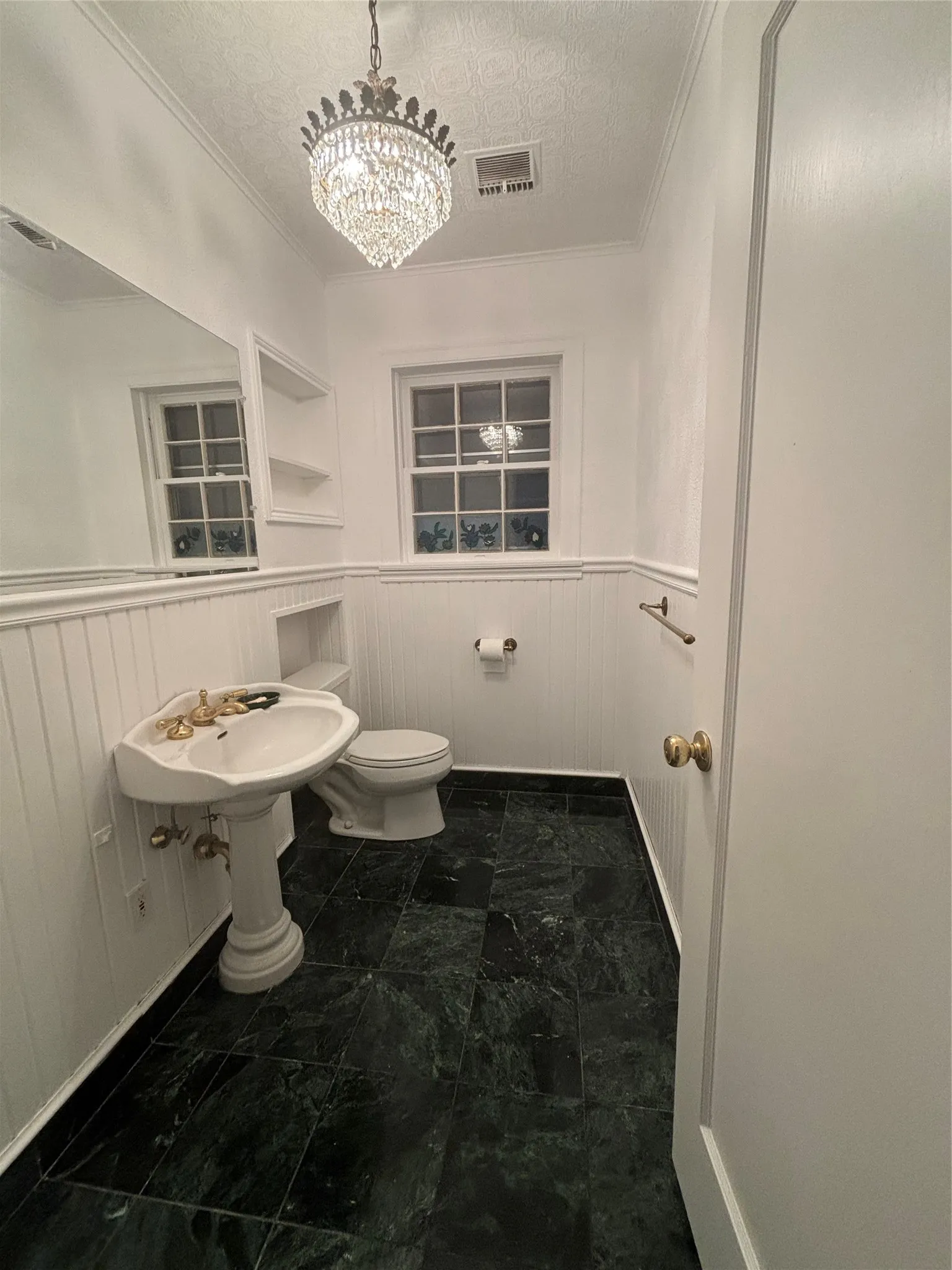 Full bathroom with crown molding, a chandelier, and a textured ceiling