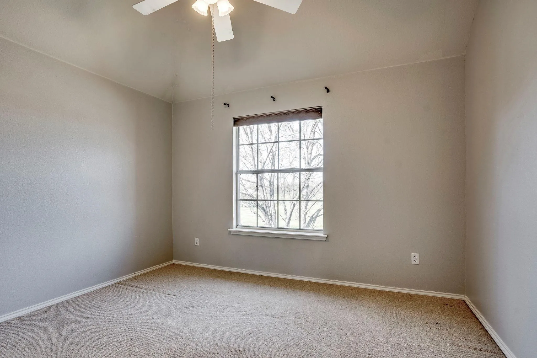 Window with horizontal blinds, carpeted flooring, and a ceiling fan with integrated lighting