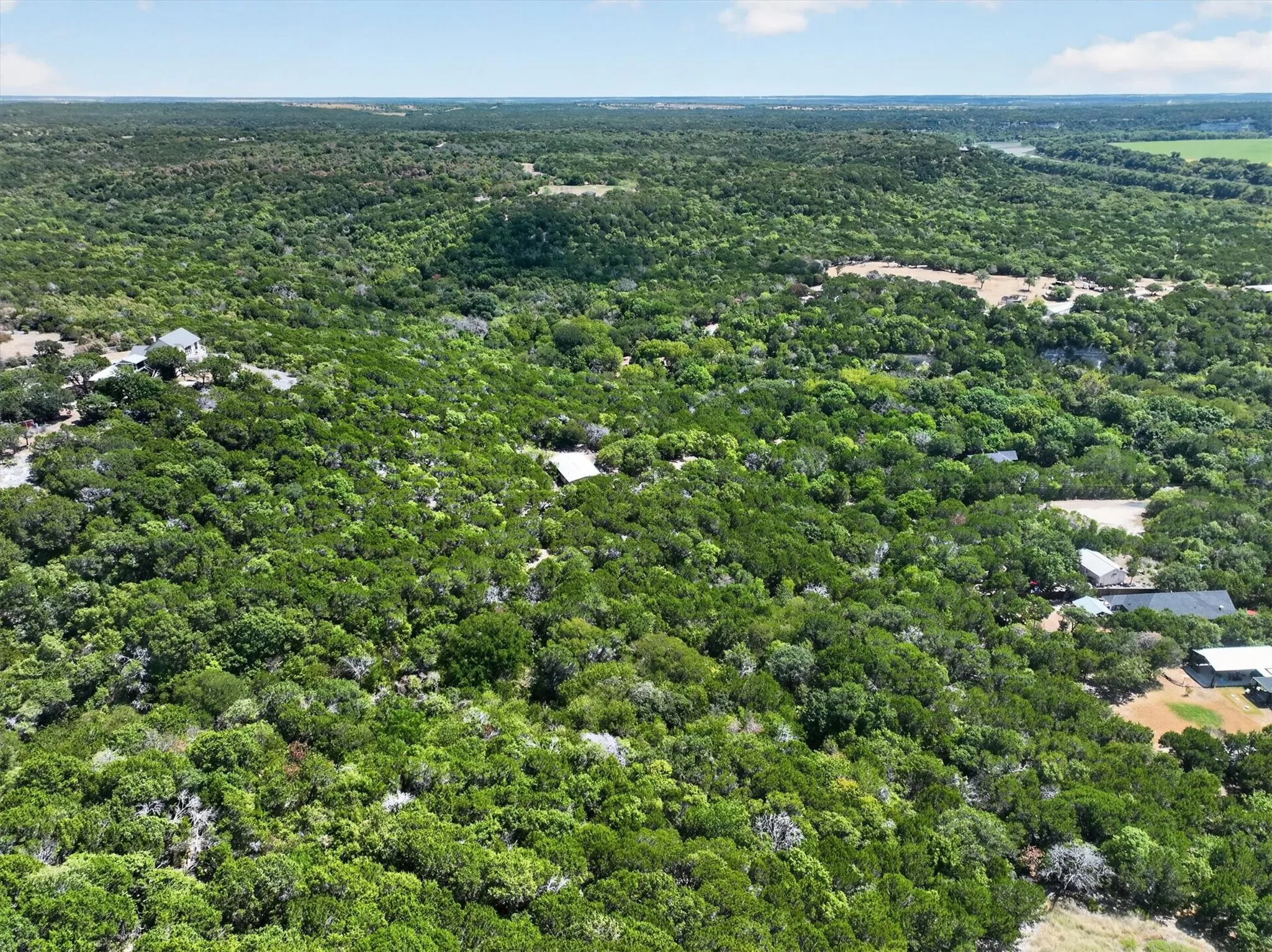 Expansive treed acreage with multiple structures