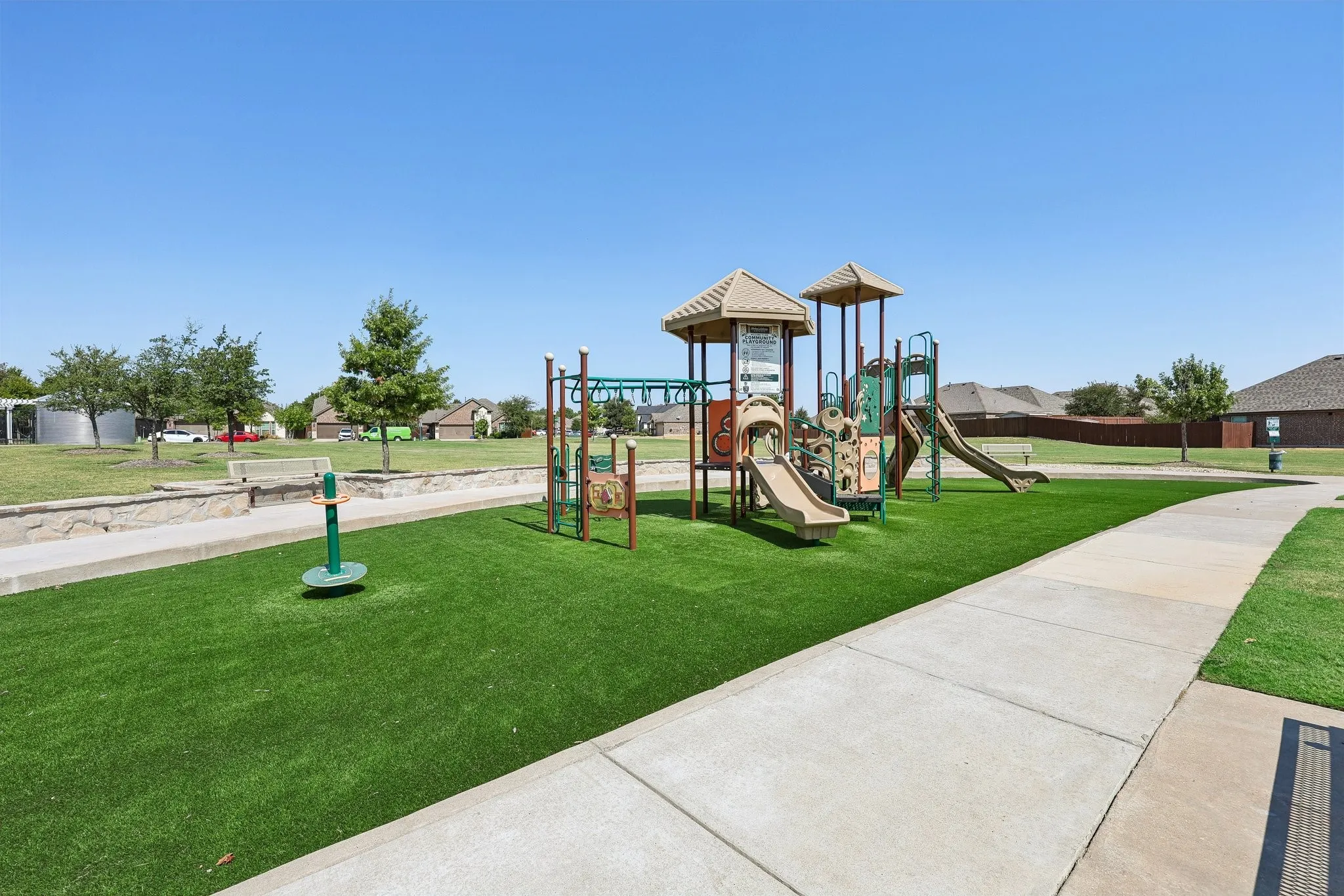 Community playground featuring multiple slides, climbing structures, and soft-surface ground cover
