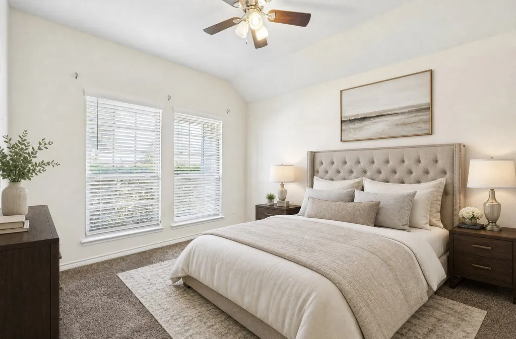 Vaulted ceiling with a ceiling fan, two windows with blinds, and wall-to-wall carpeting, virtually staged