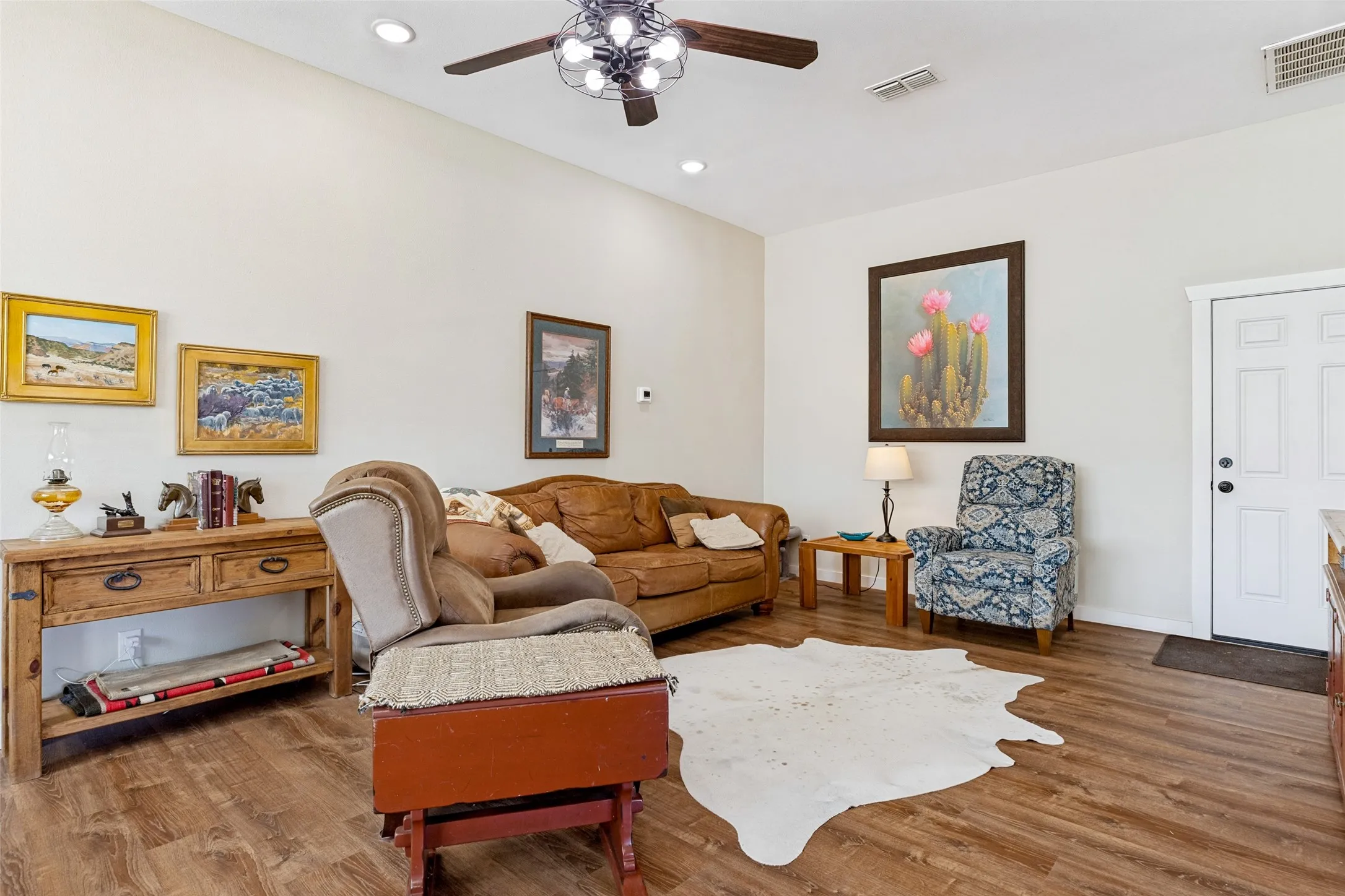 Living room with a door that leads to the horse stall and tack room.