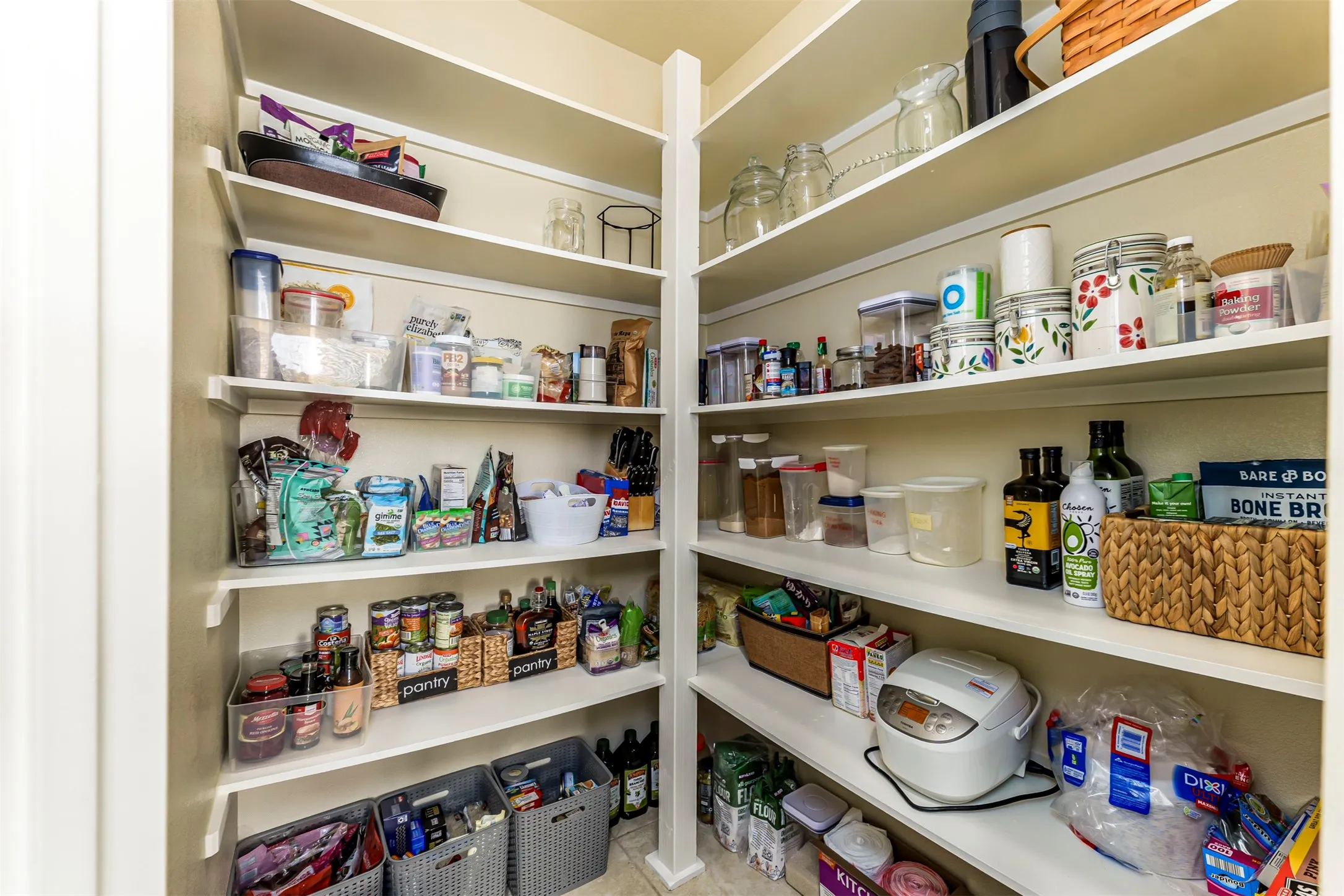 Walk-in pantry featuring extensive built-in shelving