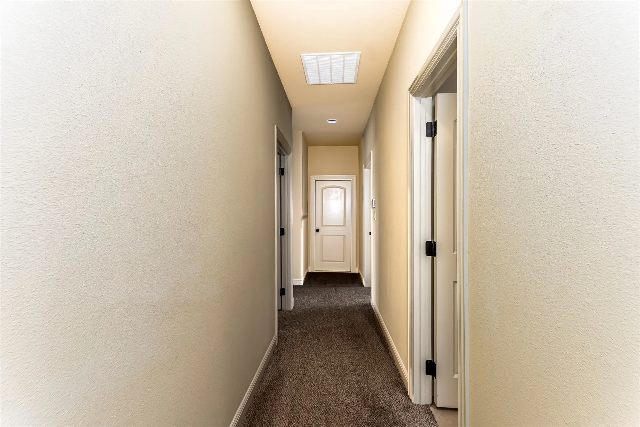 Hallway featuring textured walls, neutral paint, recessed lighting, and carpet flooring