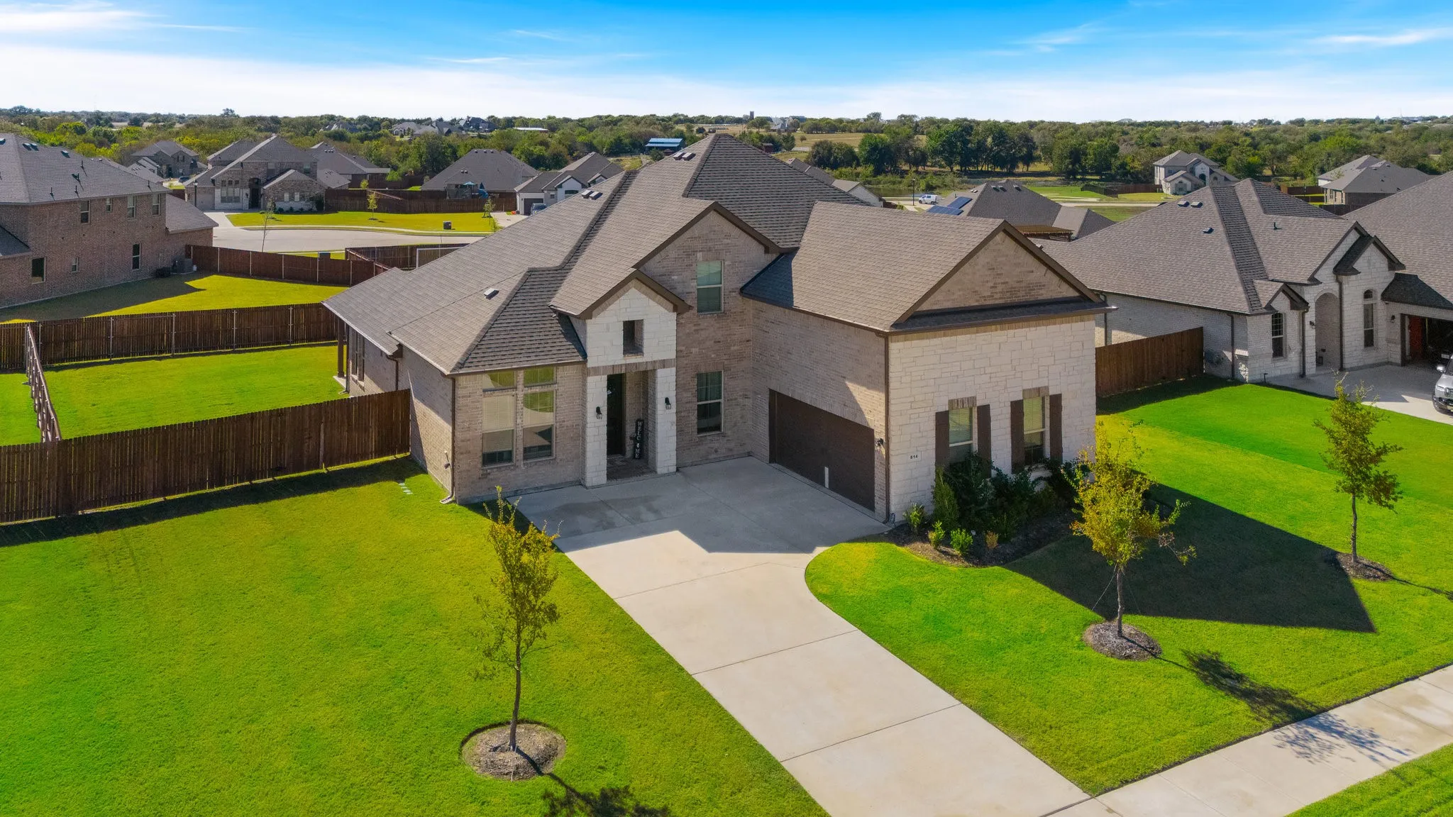 View of front of your home featuring a J-swing driveway, a fenced backyard,