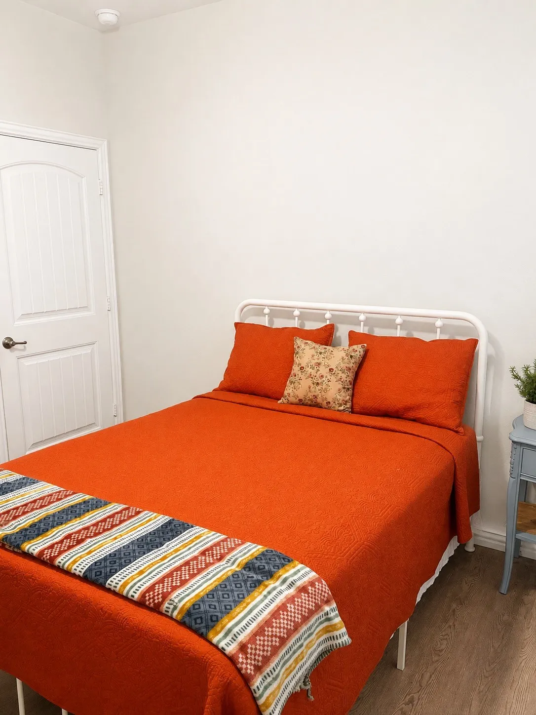 Wood-finish flooring with a white paneled door