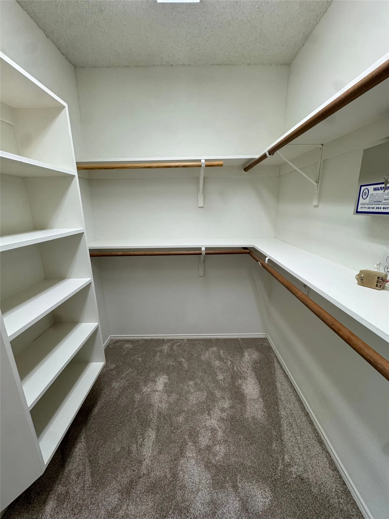 Built-in shelving, multiple hanging rods, and ample storage space