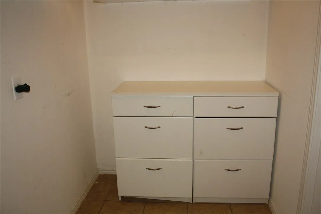 Built in cabinets located in the utility room.  There is also storage cabinetry above the drawer unit.