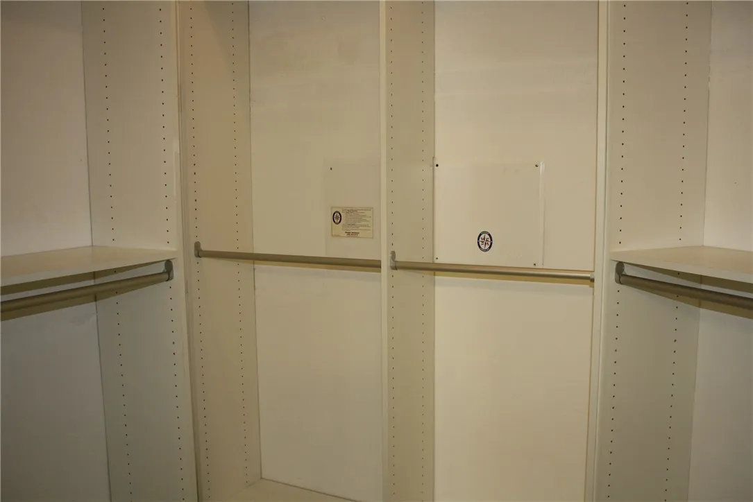 The closet located off the primary bath features a customized closet system.