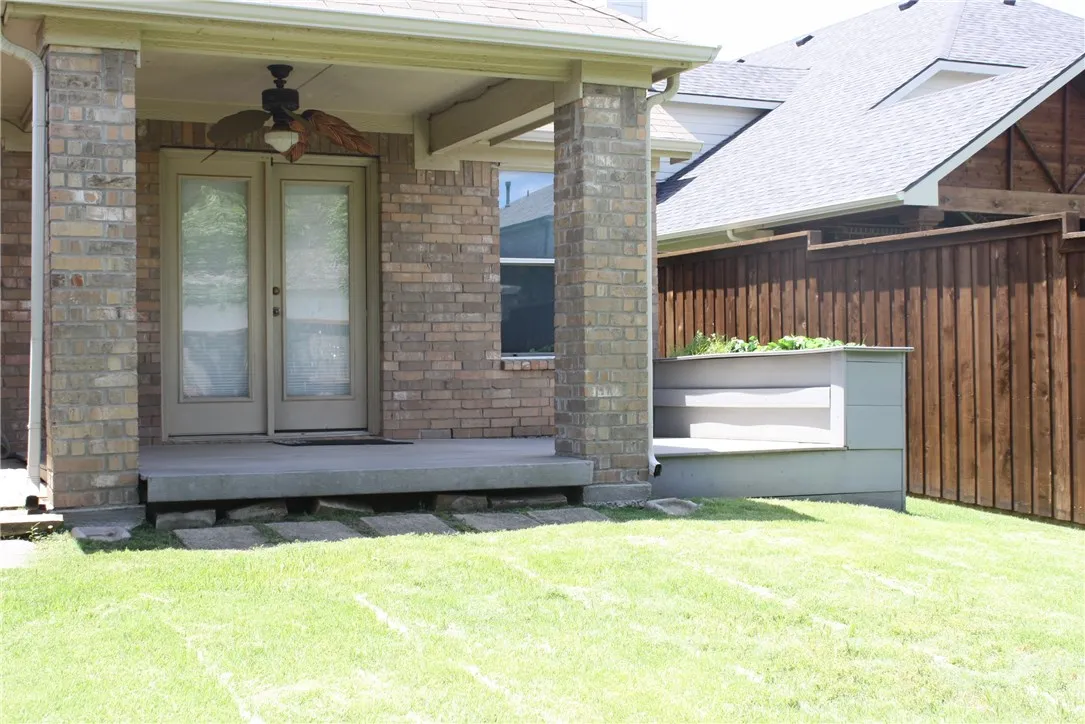 Enter the back patio from the family room.  Enjoy the outdoors with the comfort of a ceiling fan and a lighting system.