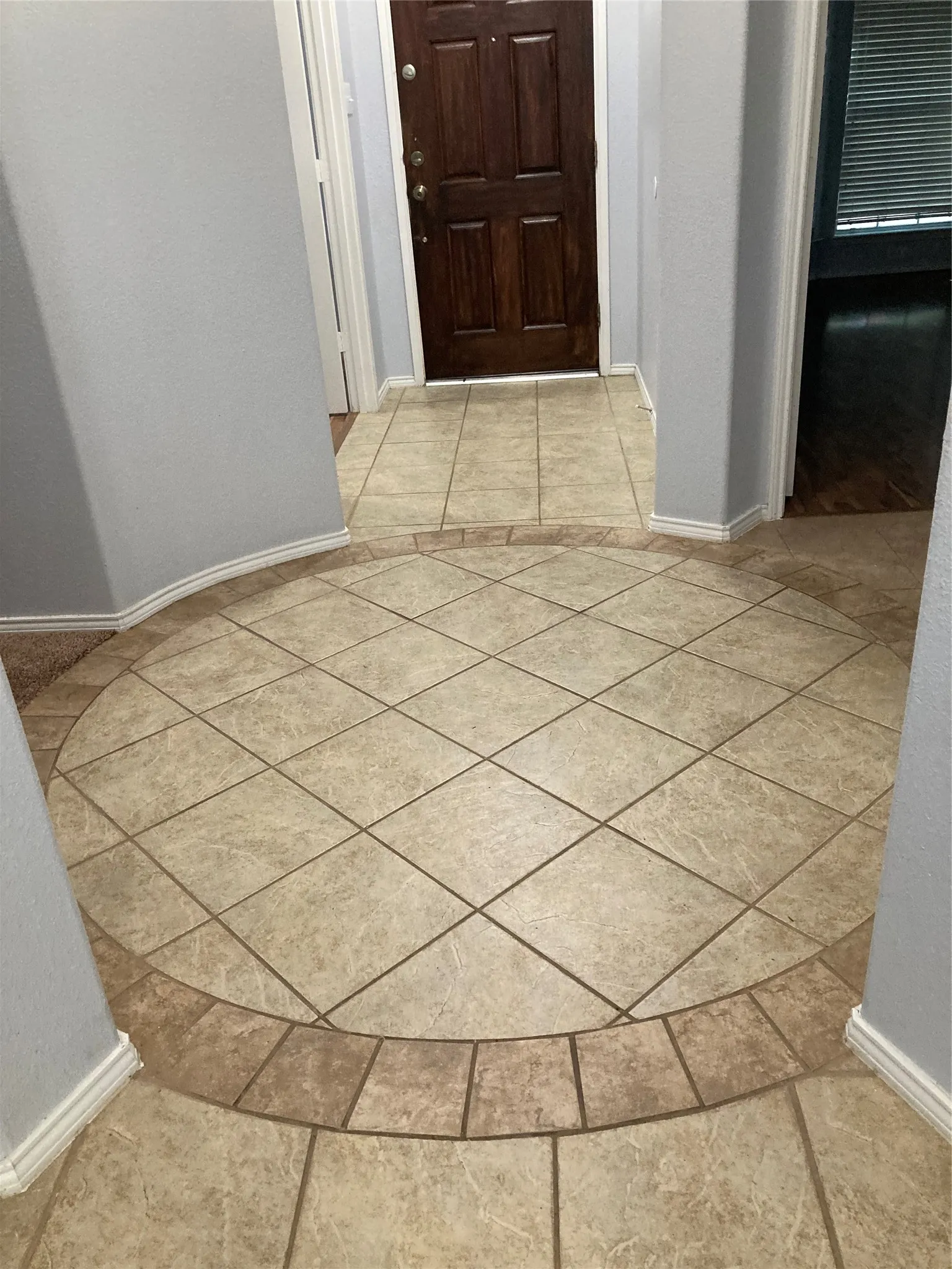 The entryway features an impressive circular tile pattern.