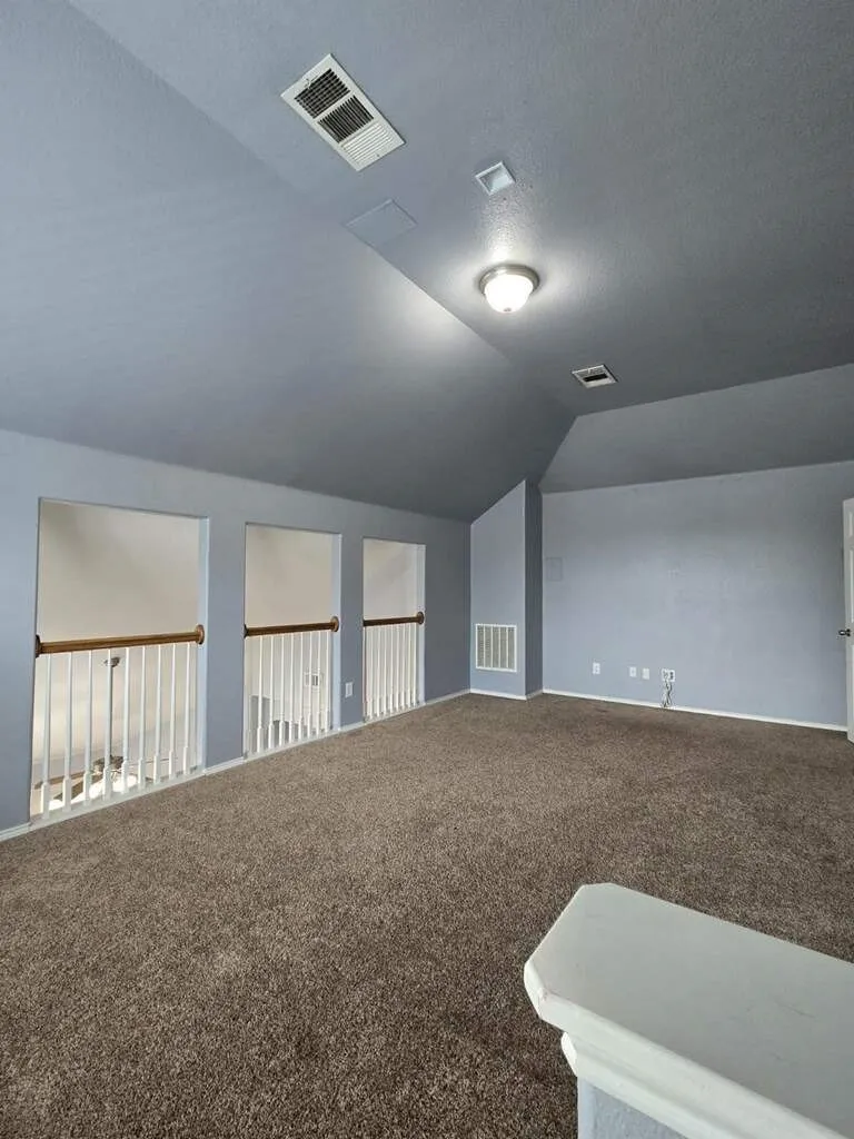Game room/media room overlooks the family room below.  There are built-in speakers and wiring for media equipment located on the far wall.