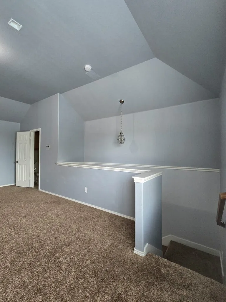 Game room/media room, located upstairs, has a half bath that is entered through the door shown in this photo.