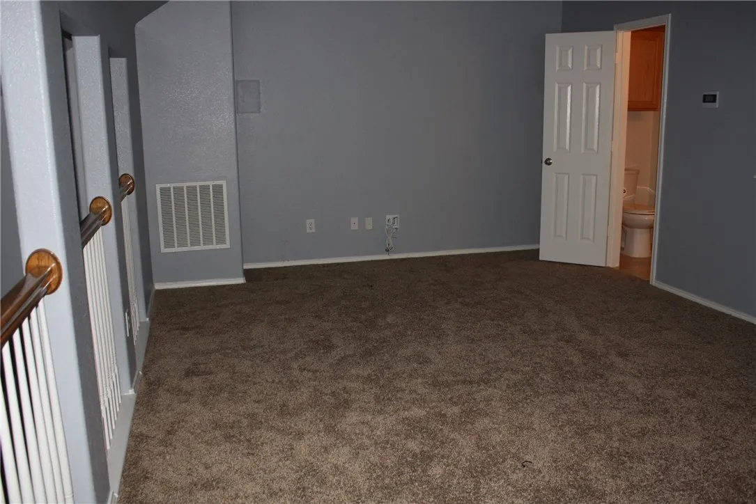Another view of the media/game room upstairs and the adjoining half bath.