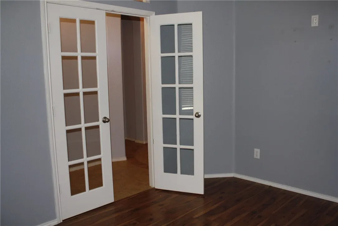 Study features laminate wood floors and French doors and is located off the foyer.