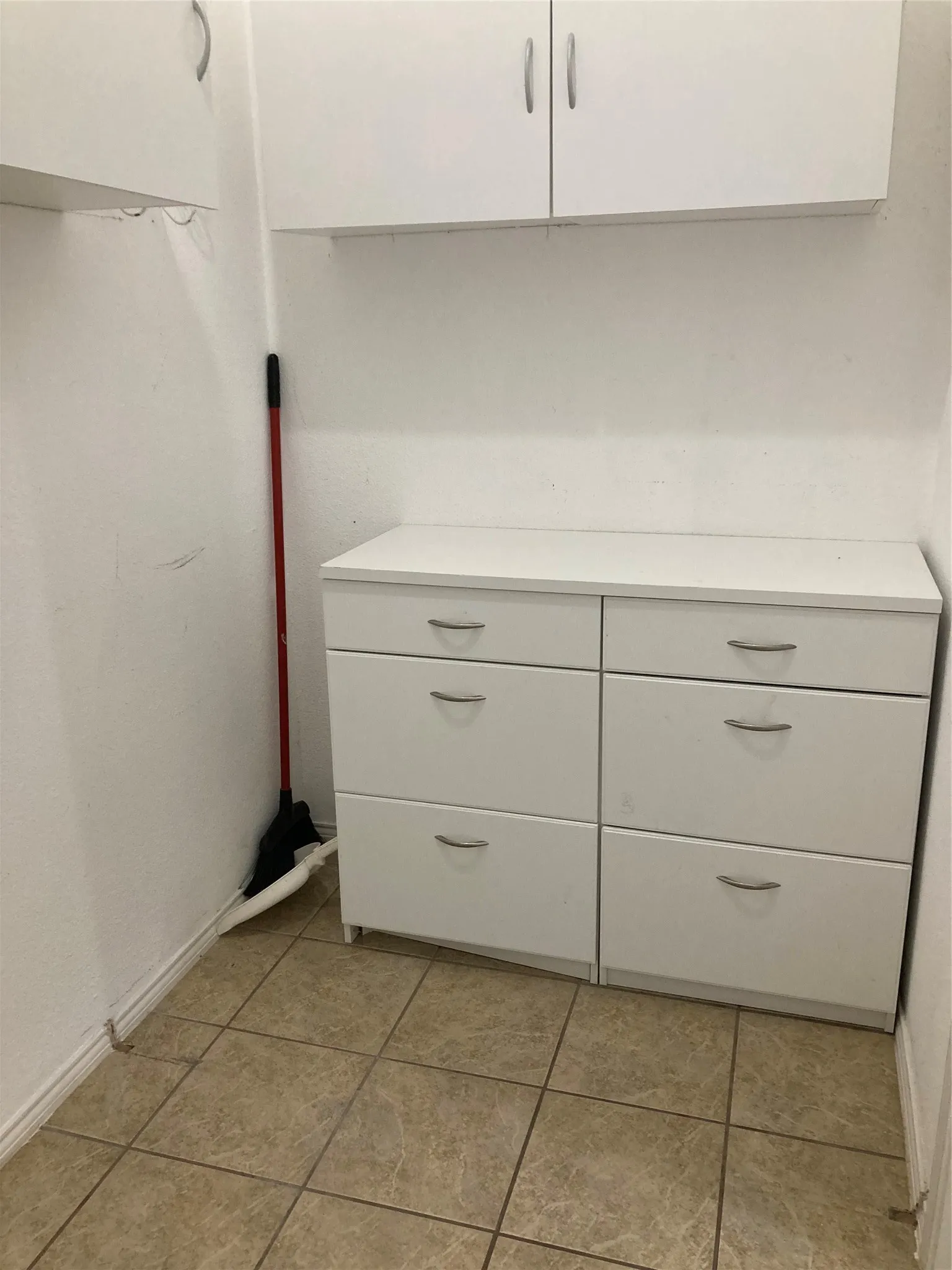 Cabinets located in the combination pantry/utility room.