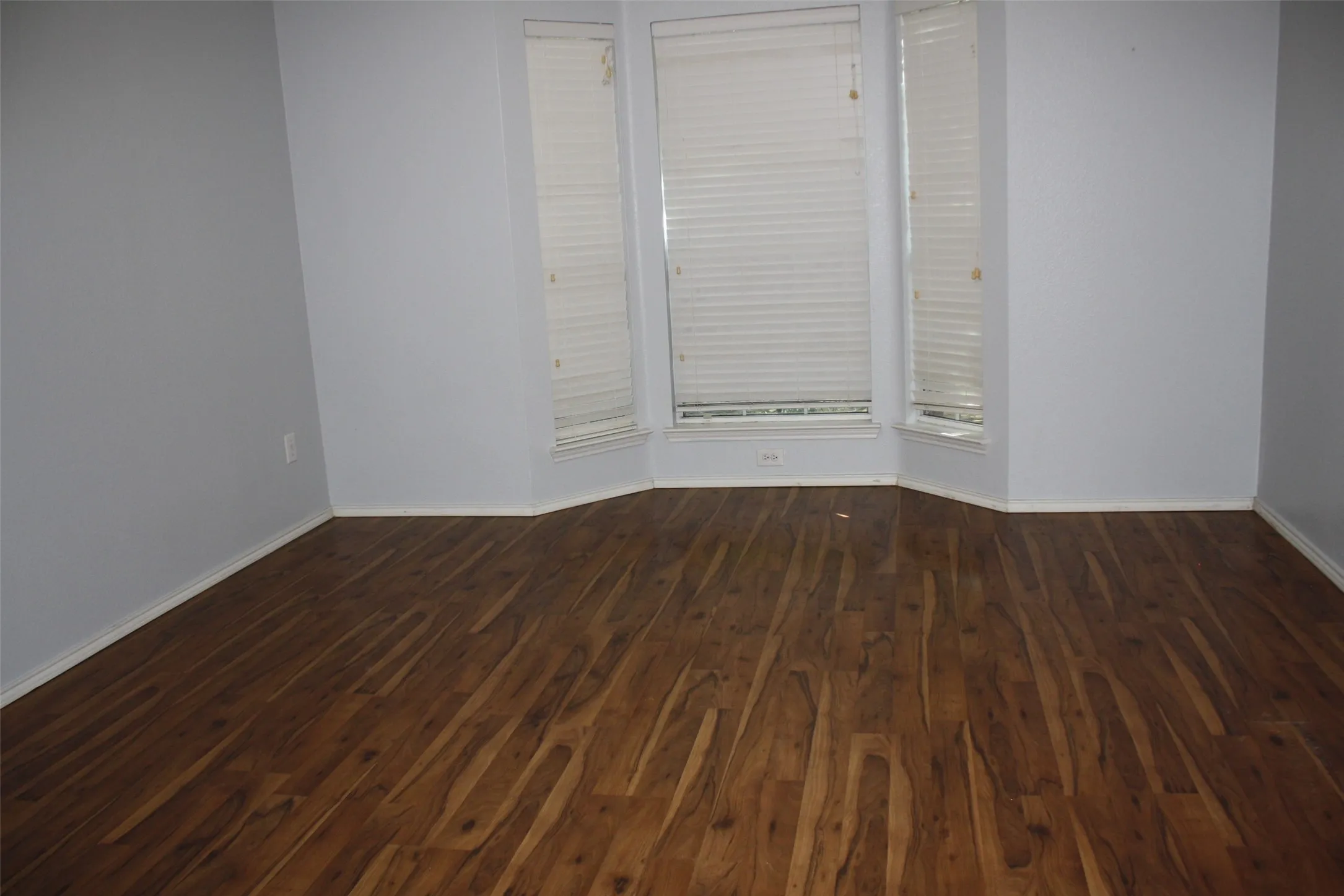 Primary bedroom features a bay window that overlooks the front yard.