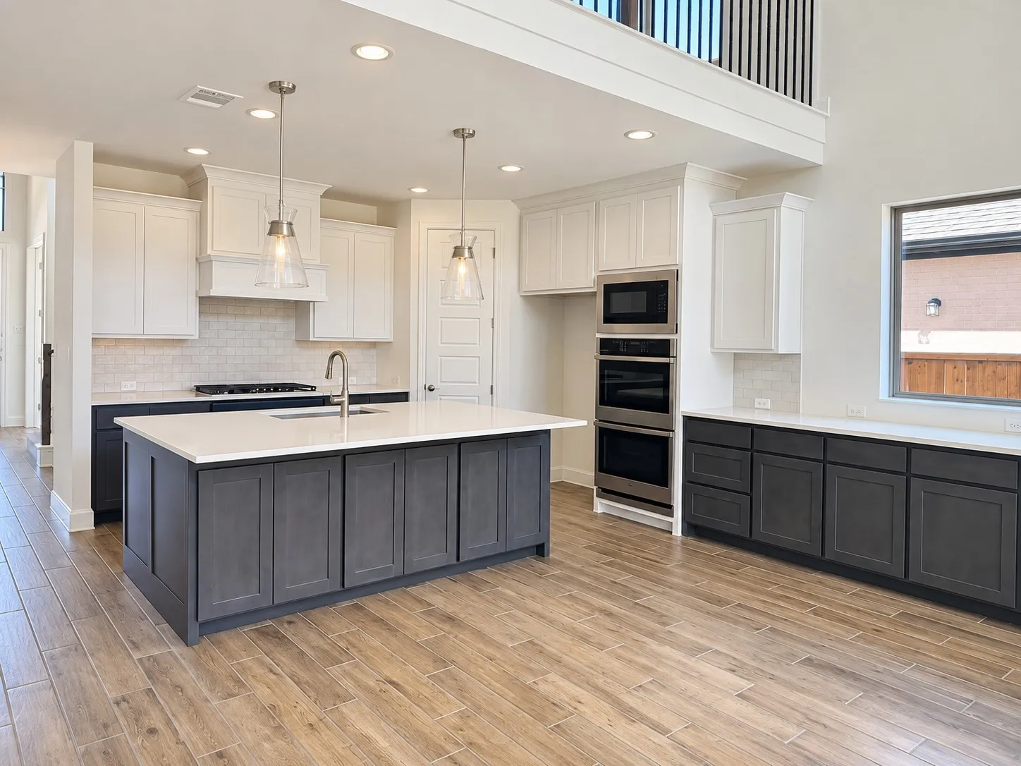 Soaring ceilings with a decorative fan and recessed lighting