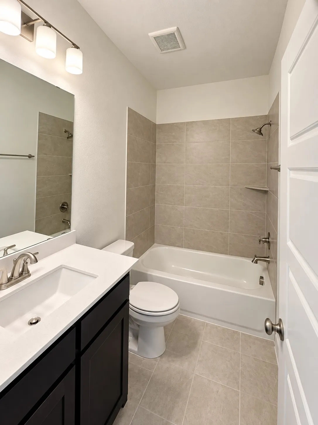Vanity with white countertop, undermount sink, and brushed nickel faucet