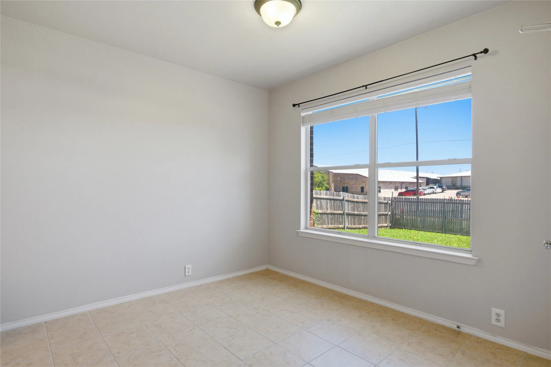Neutral wall finishes, recessed window, tile flooring, and flush-mount ceiling light fixture