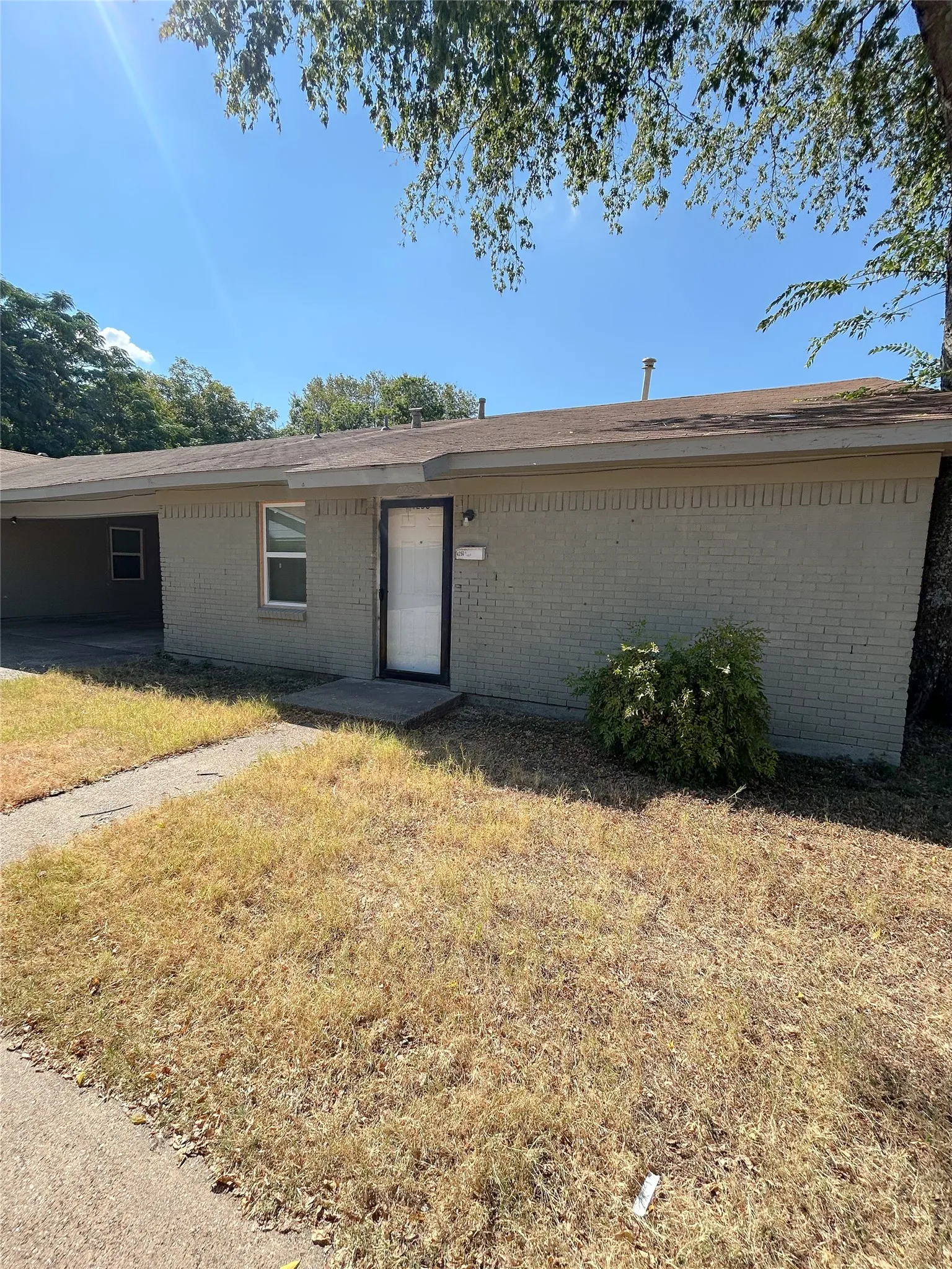 Brick exterior, covered entry, and concrete walkway