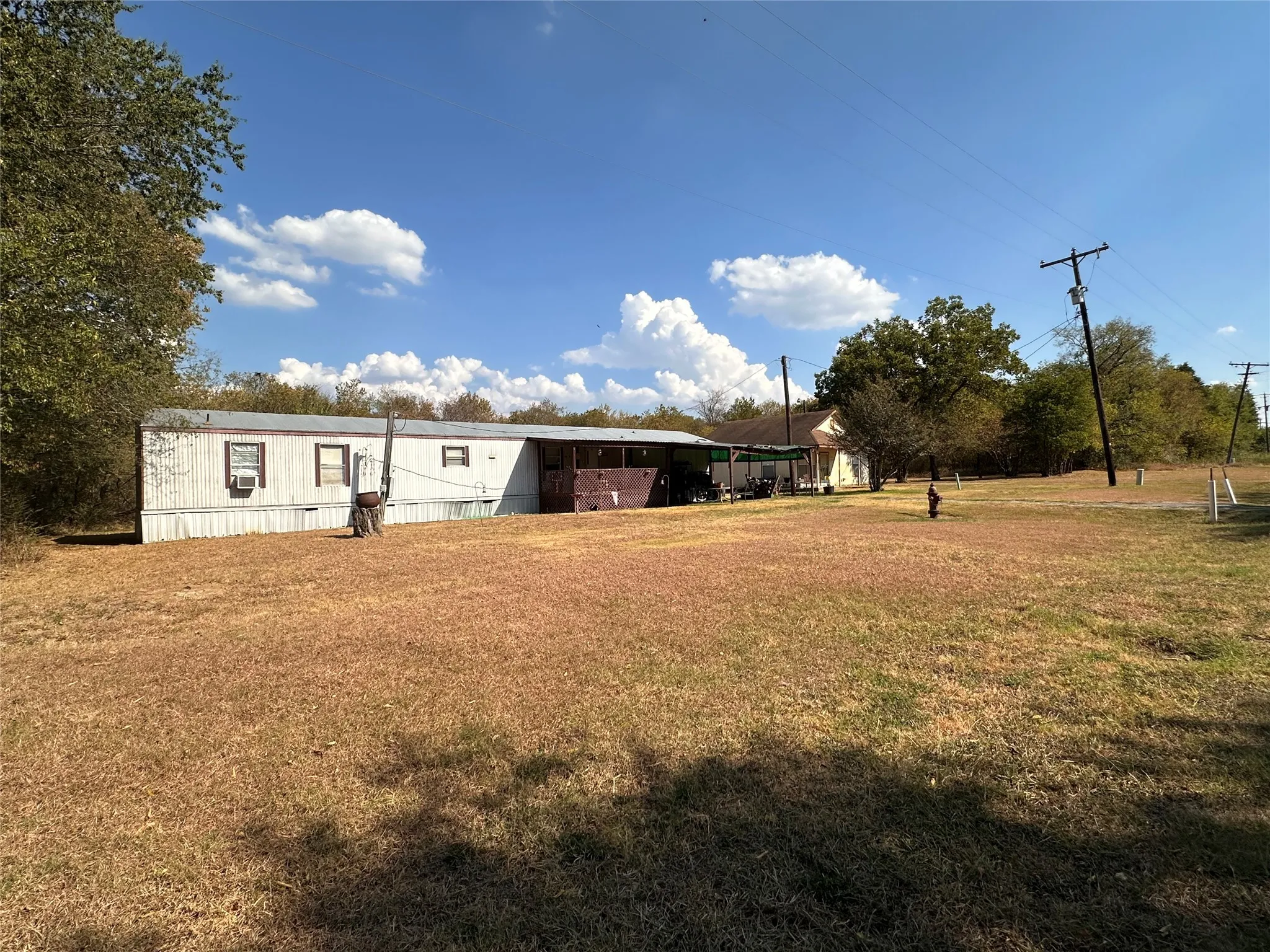Street View showing both homes and lot at far end.