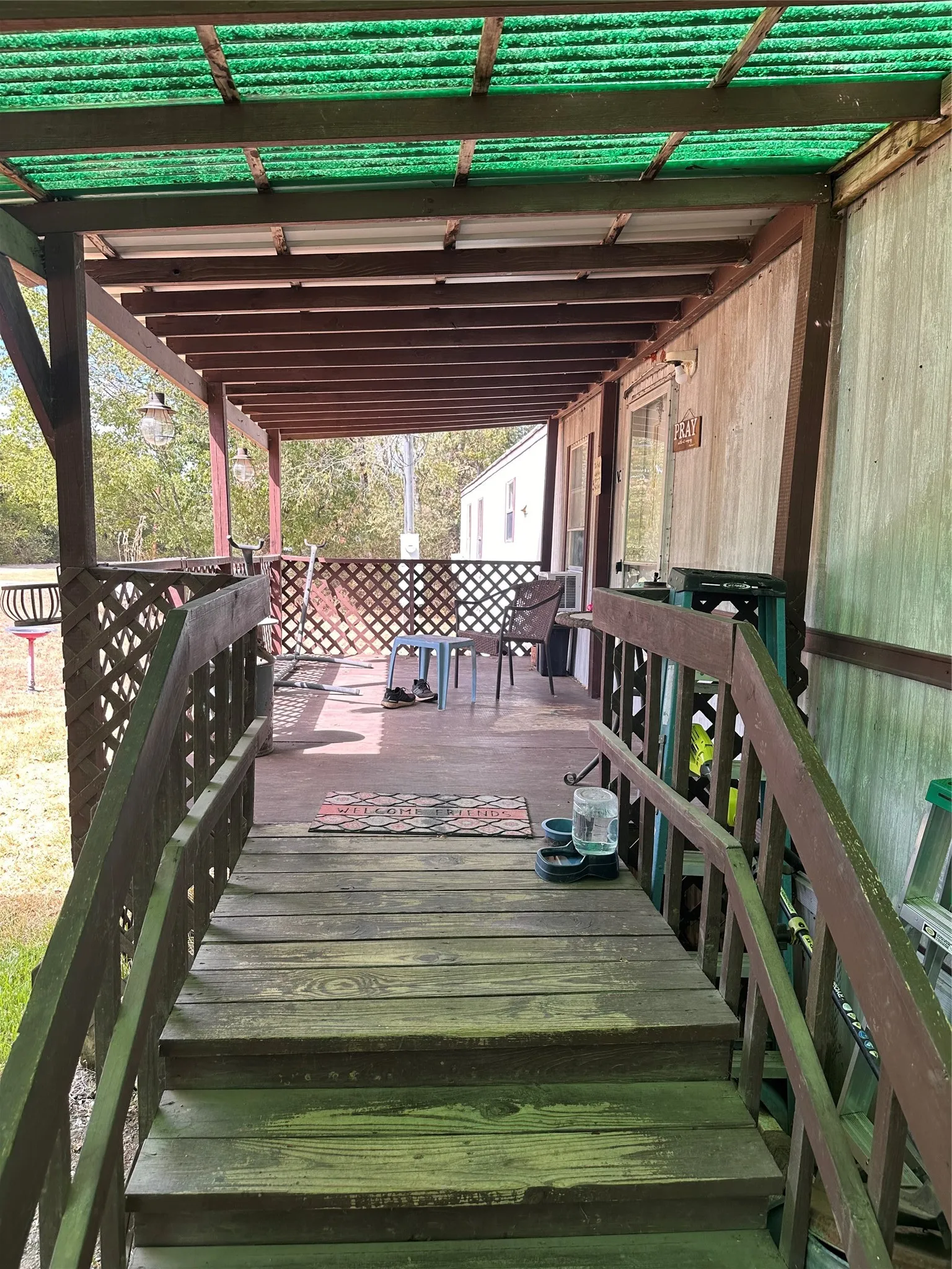 Covered porch with wood-finish steps and railing