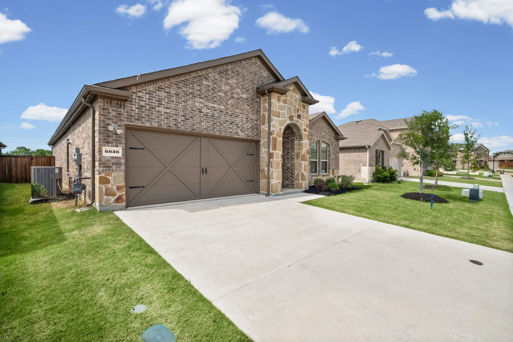 Brick and stone exterior with an arched entryway