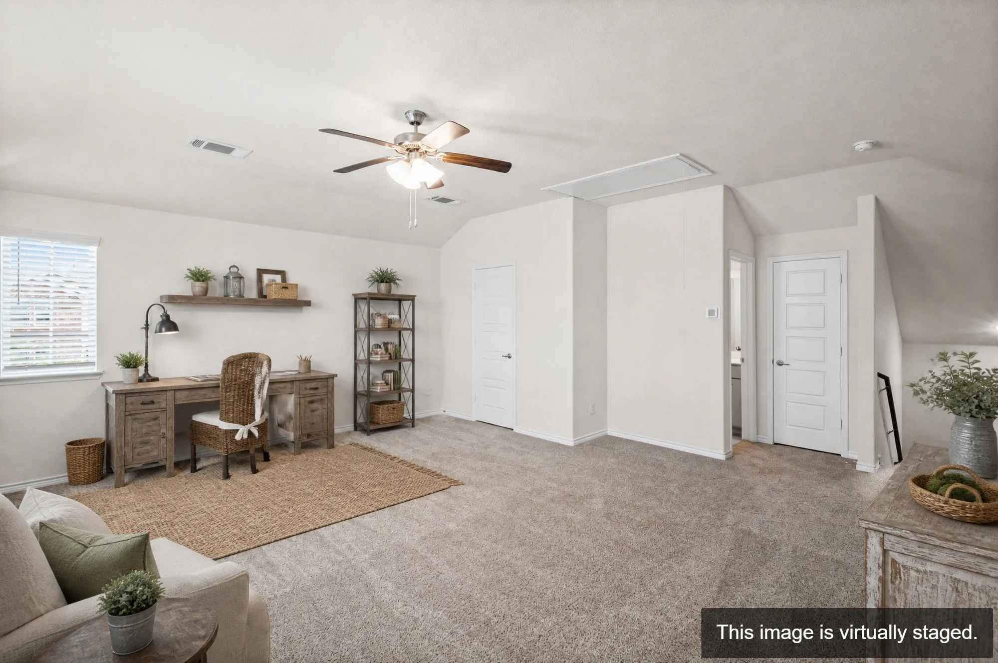 Spacious room with sloped ceilings and light-toned carpeting