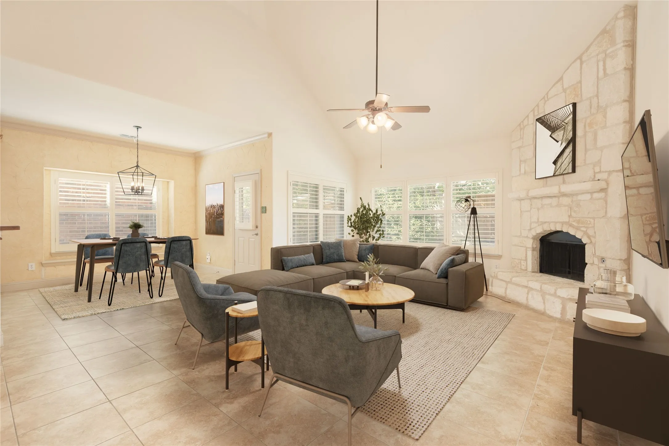 VIRTUALLY STAGED FAMILY ROOM & BREAKFAST ROOM
Vaulted ceiling with ceiling fan, stone-clad fireplace, plantation shutters, tiled flooring, and a dining area with pendant lighting