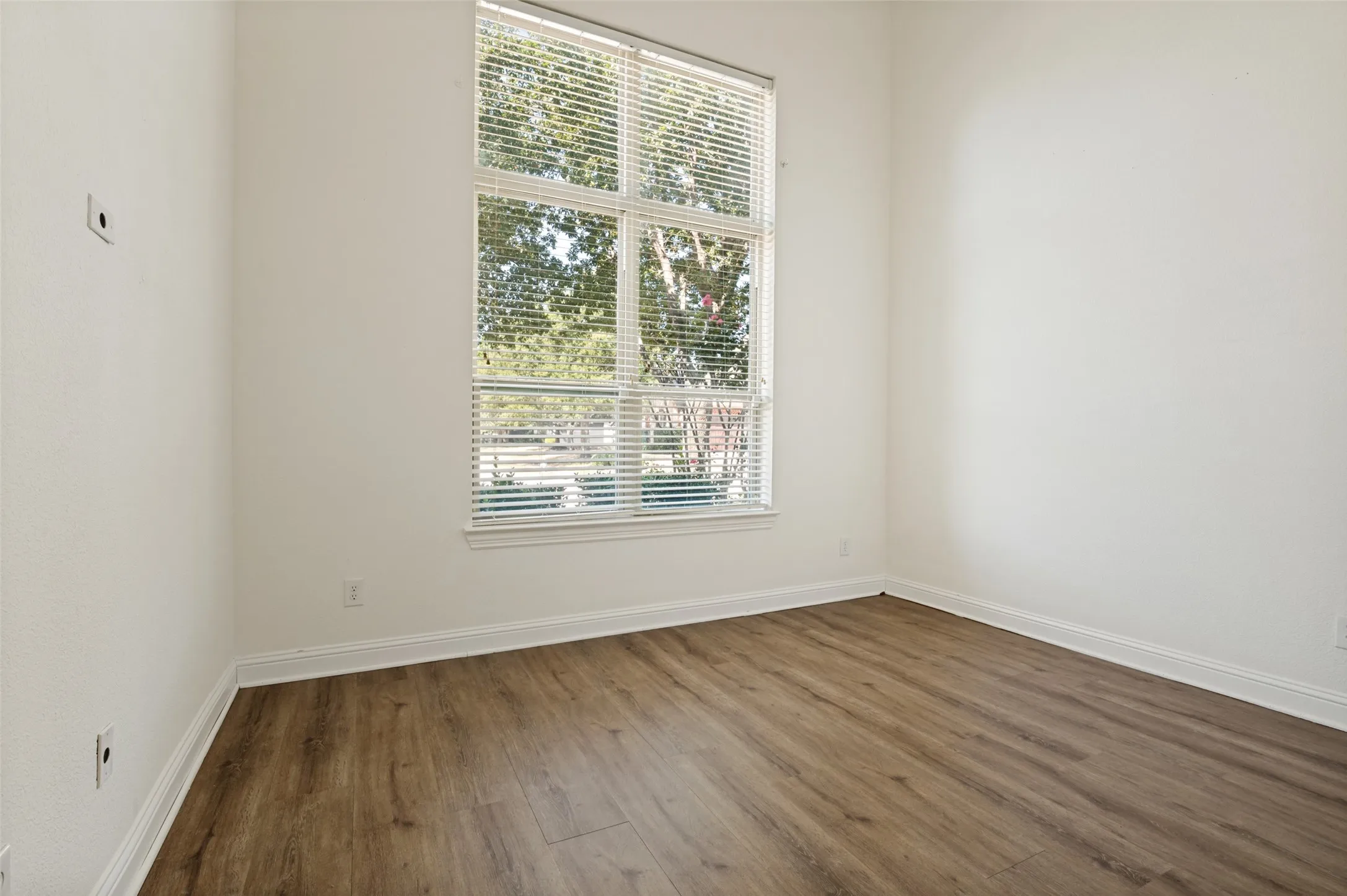 Hard-surface wood-finish flooring complements white walls