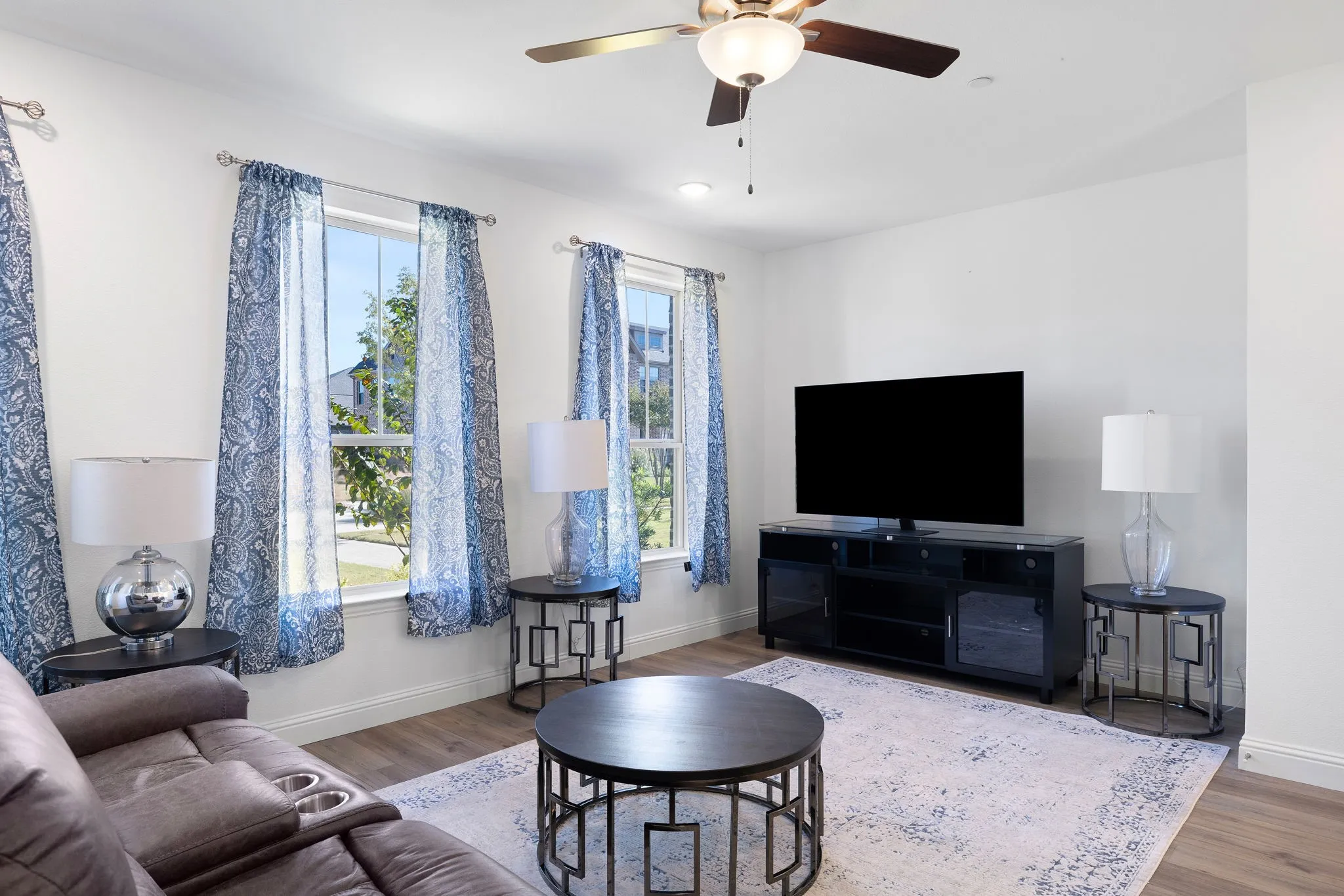 Recessed lighting, wood-finish flooring, ceiling fan, and multiple windows allowing ample natural light