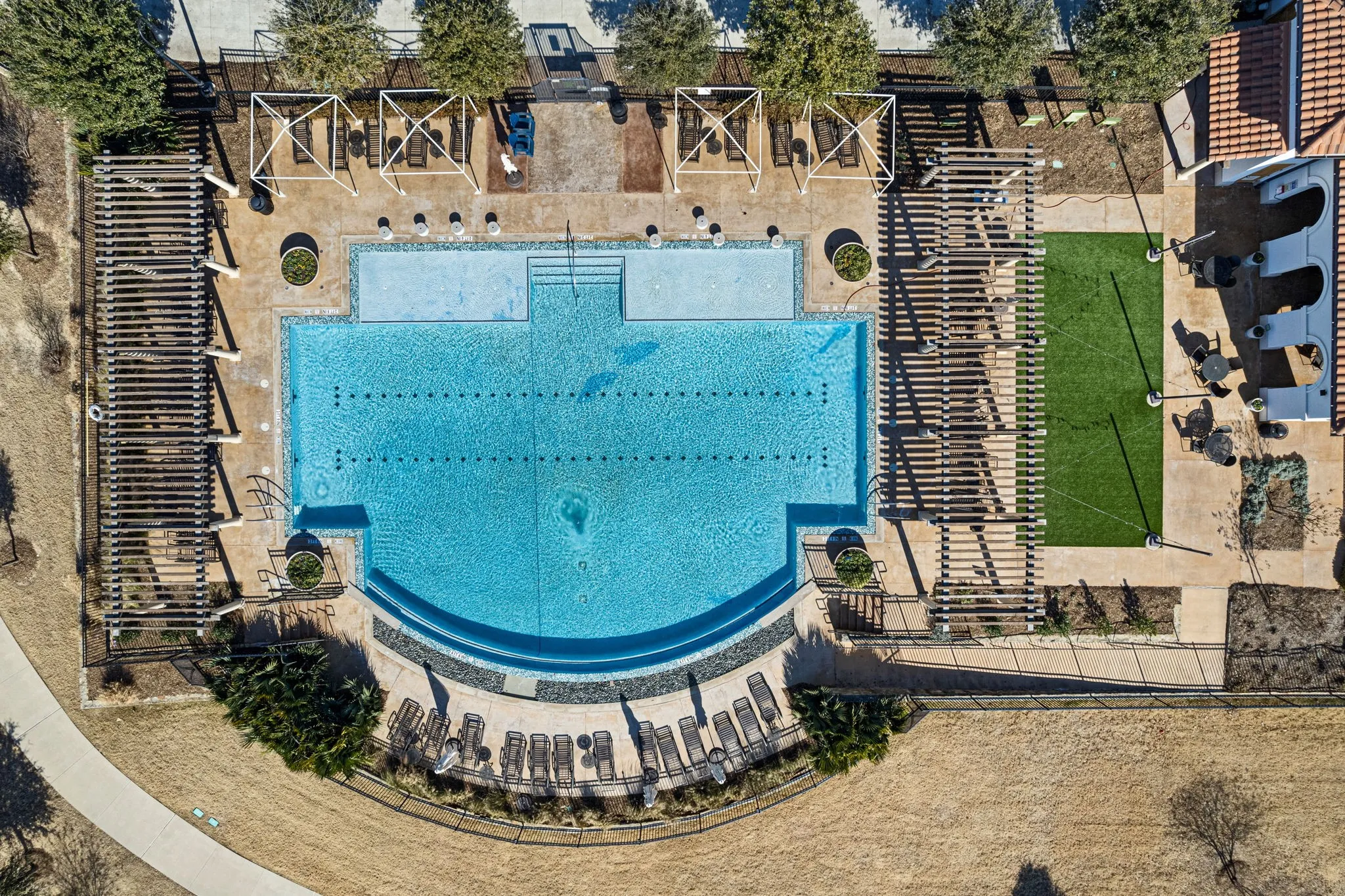Resort-style pool with integrated lap lanes and an elevated lounge area
