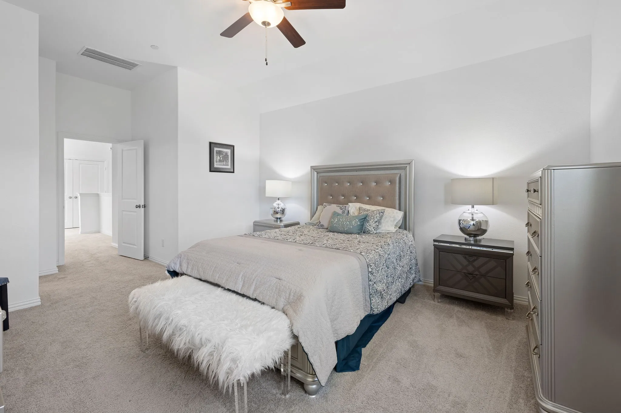 Carpeted flooring, ceiling fan with integrated lighting, recessed entryway, and neutral wall tones