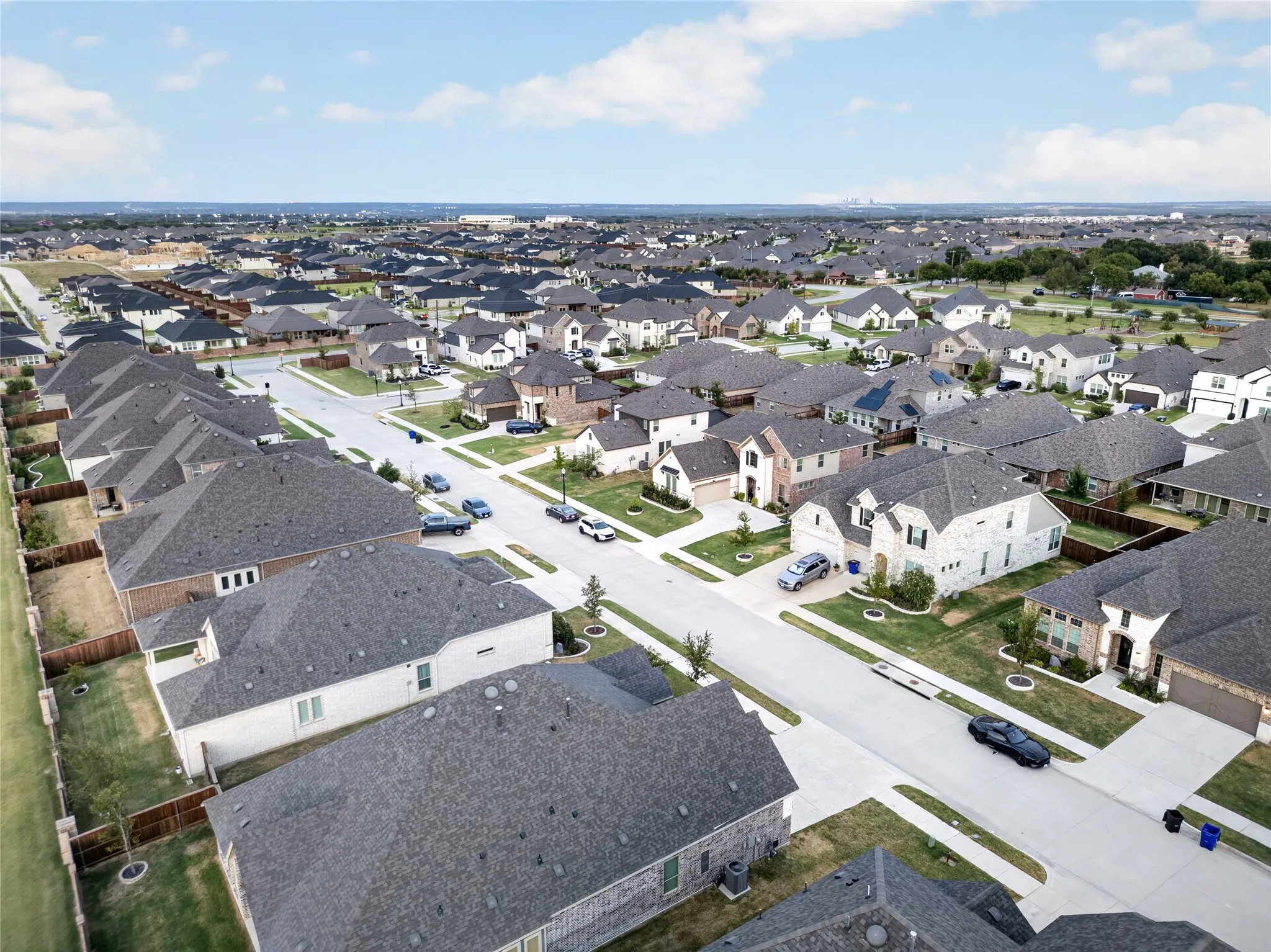 Newly constructed residential development featuring uniform rooflines and paved roadways