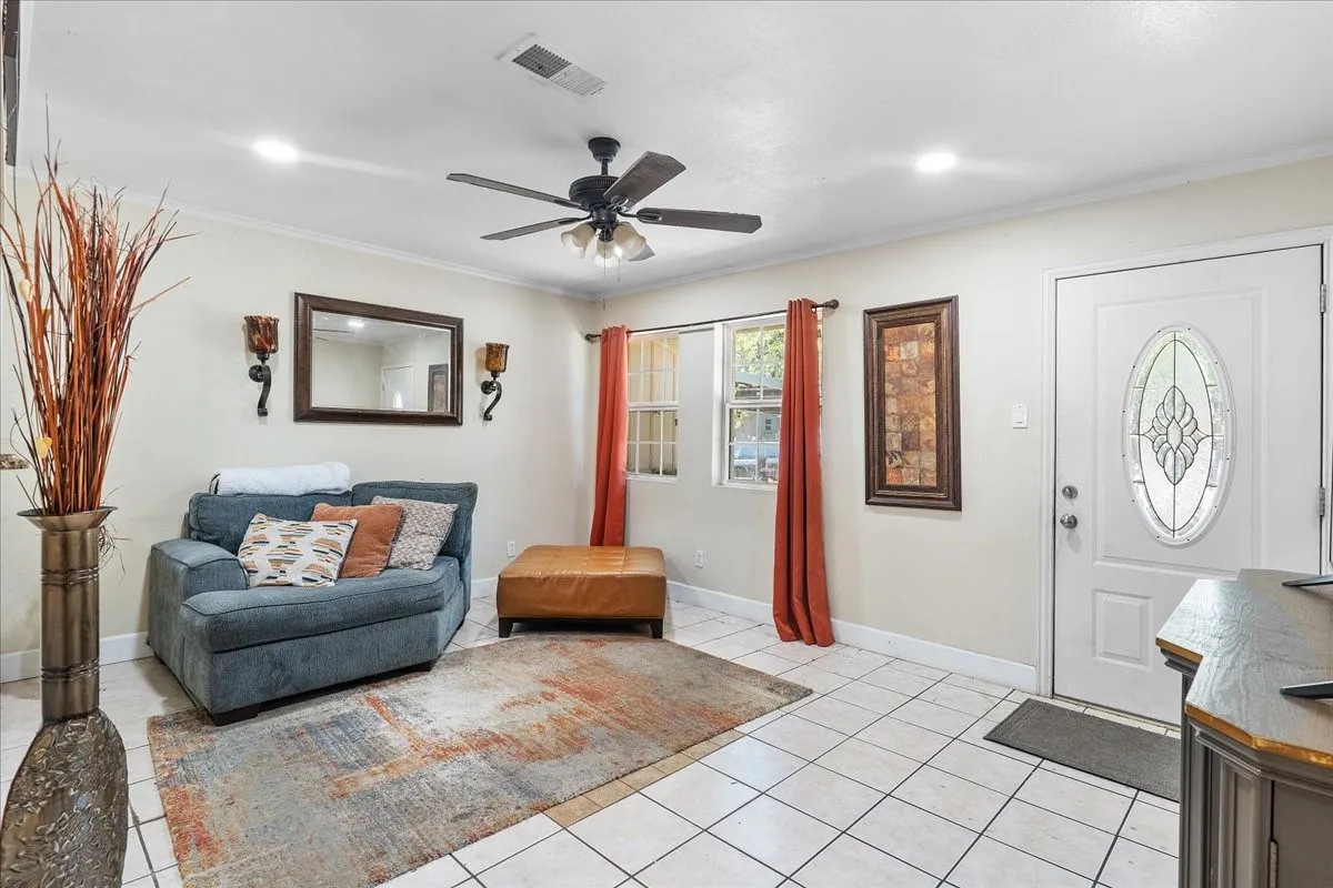Original Living room featuring recessed lighting, a ceiling fan, and a bright white-paneled entry that welcomes you into the home.