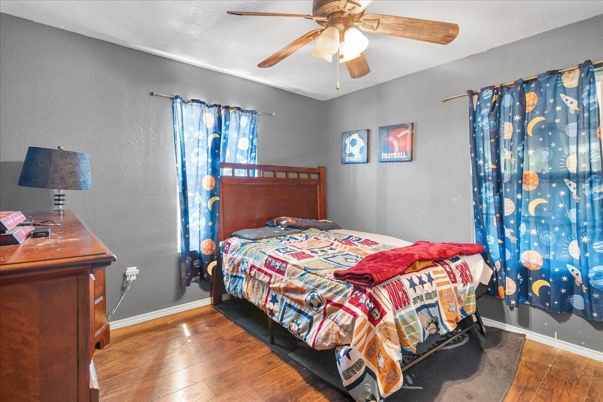 Original Photo- Bedroom 4 Wood-finish flooring with a ceiling fan light fixture