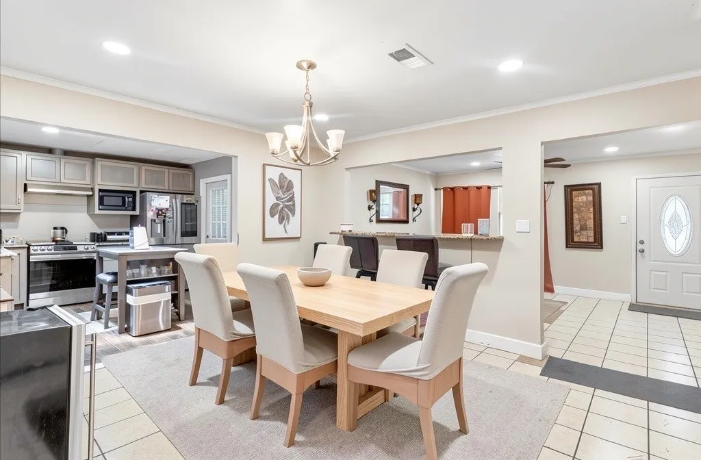 Open dining area connected to the kitchen, which features stainless-steel appliances and a functional layout for everyday living.
