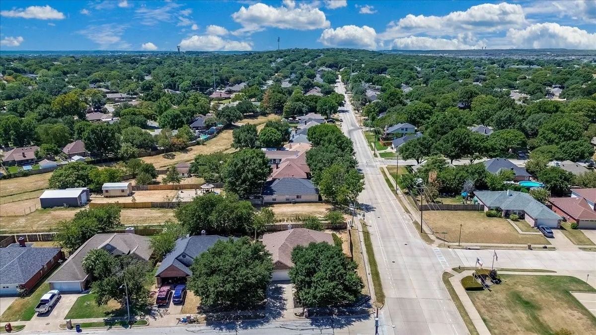 Residential street with mature tree canopy and established homes