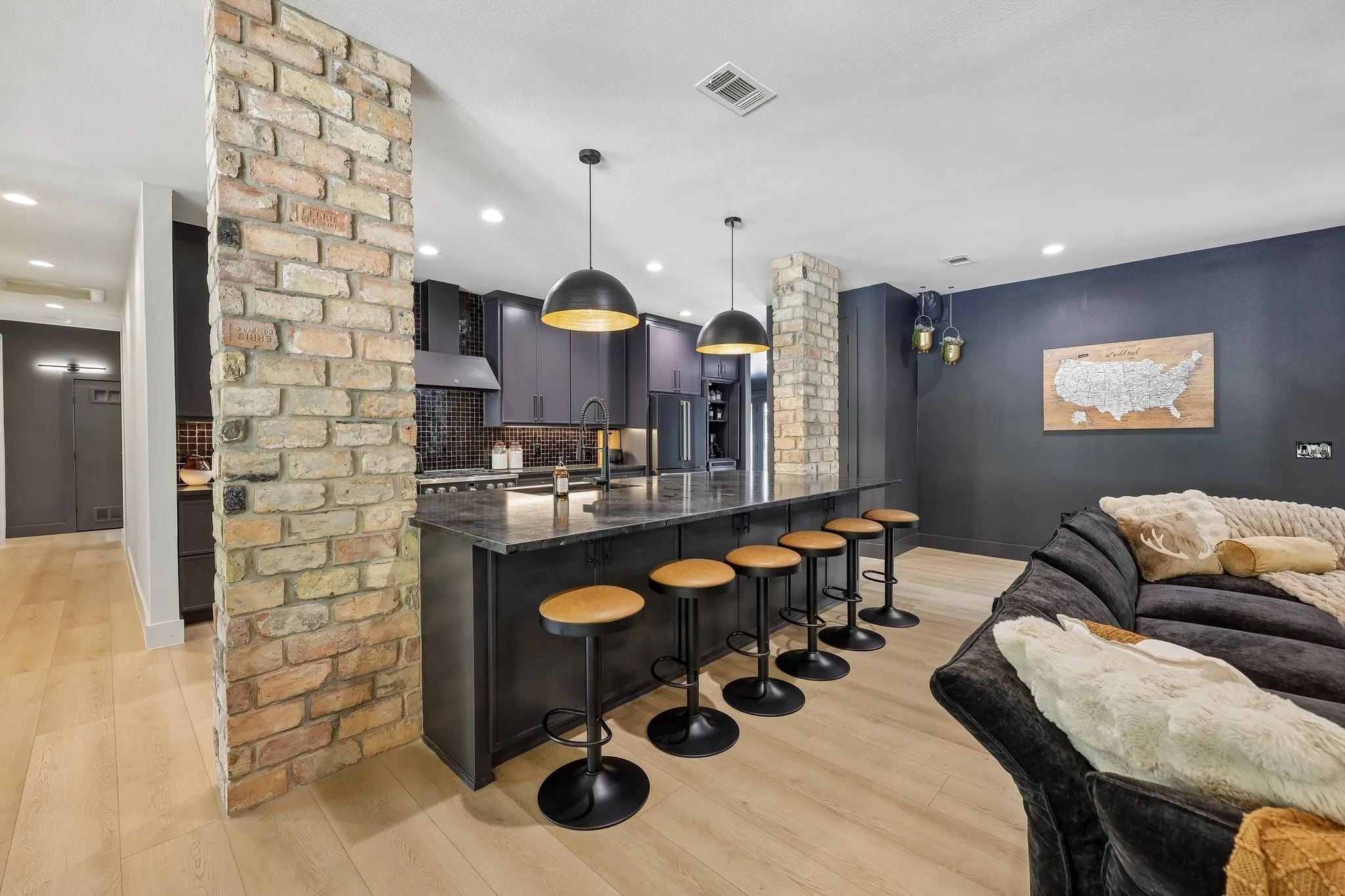 Honed granite countertops & seating for 6 at this massive kitchen island.