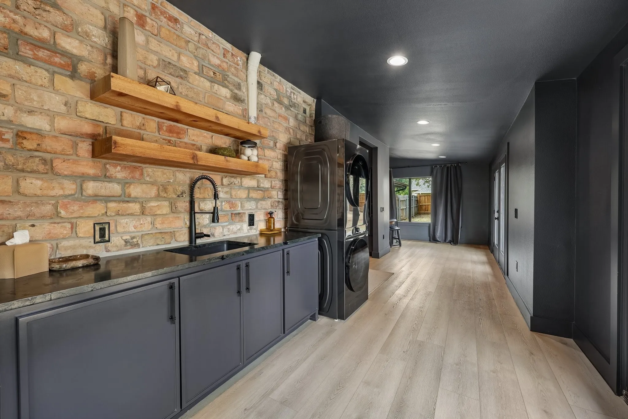 Laundry room with sink plus lots of space for folding, crafting or whatever you need this flexible space to be.