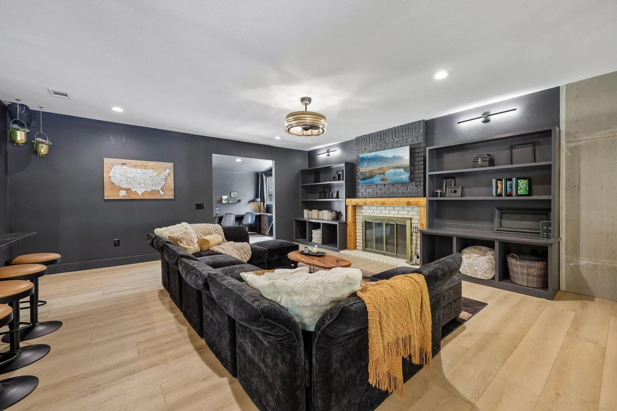 Main living room features a wood burning fireplace and great built ins on both sides. TV is mounted above the fireplace with no messy cords.