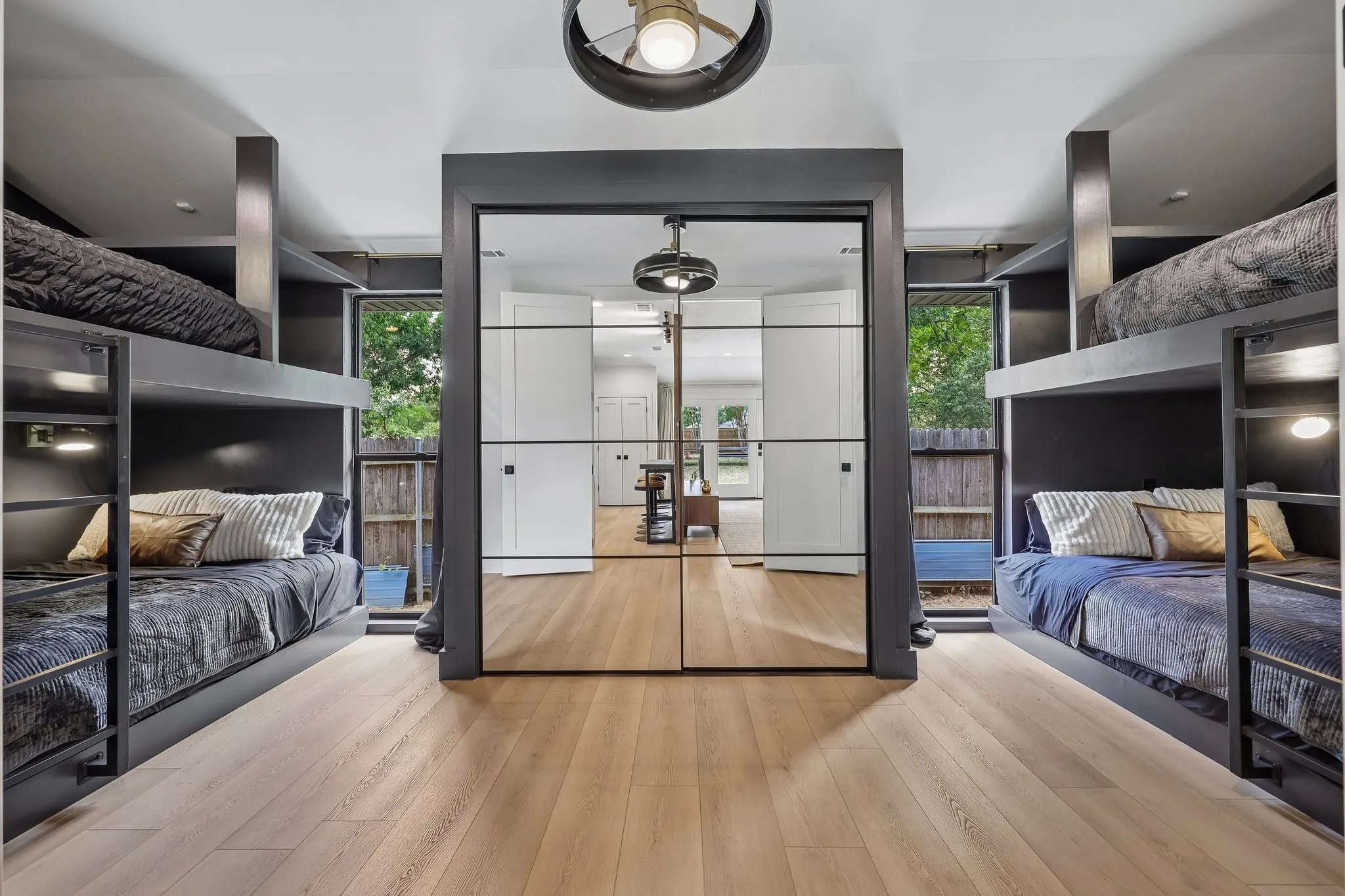 Two queen-over-queen bunk beds (4 queen beds total) sleep up to 8 guests. Every bed
includes its own reading light, charging outlet, bedside ledge, and a large built-in
storage shelf for luggage and personal belongings.