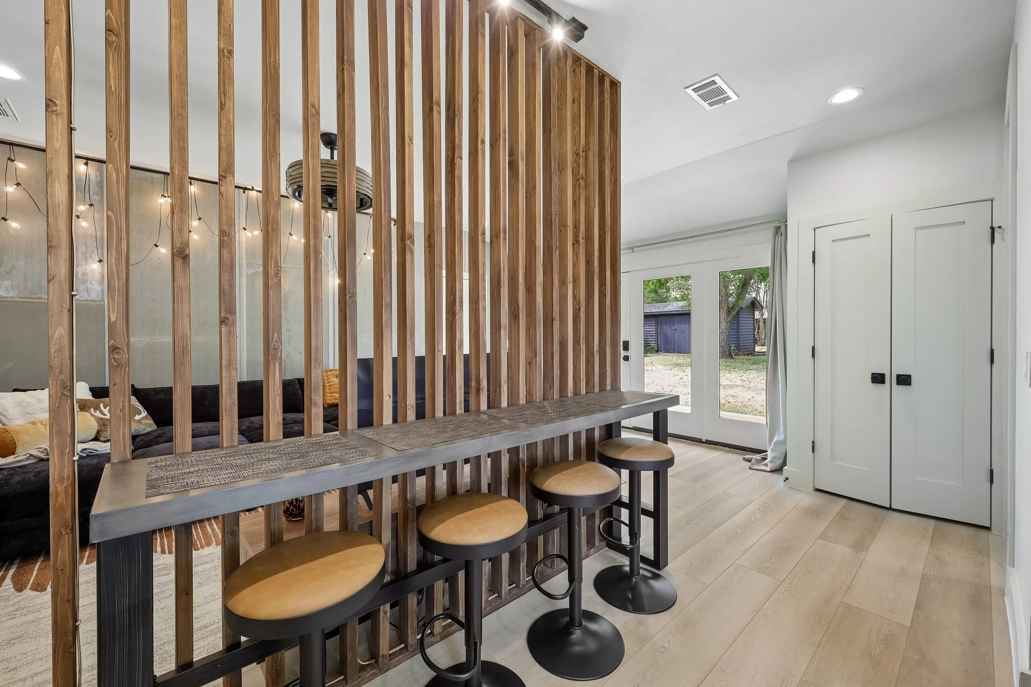 Guest house has its own laundry facilities tucked behind those closet doors and built in bar with seating for four.