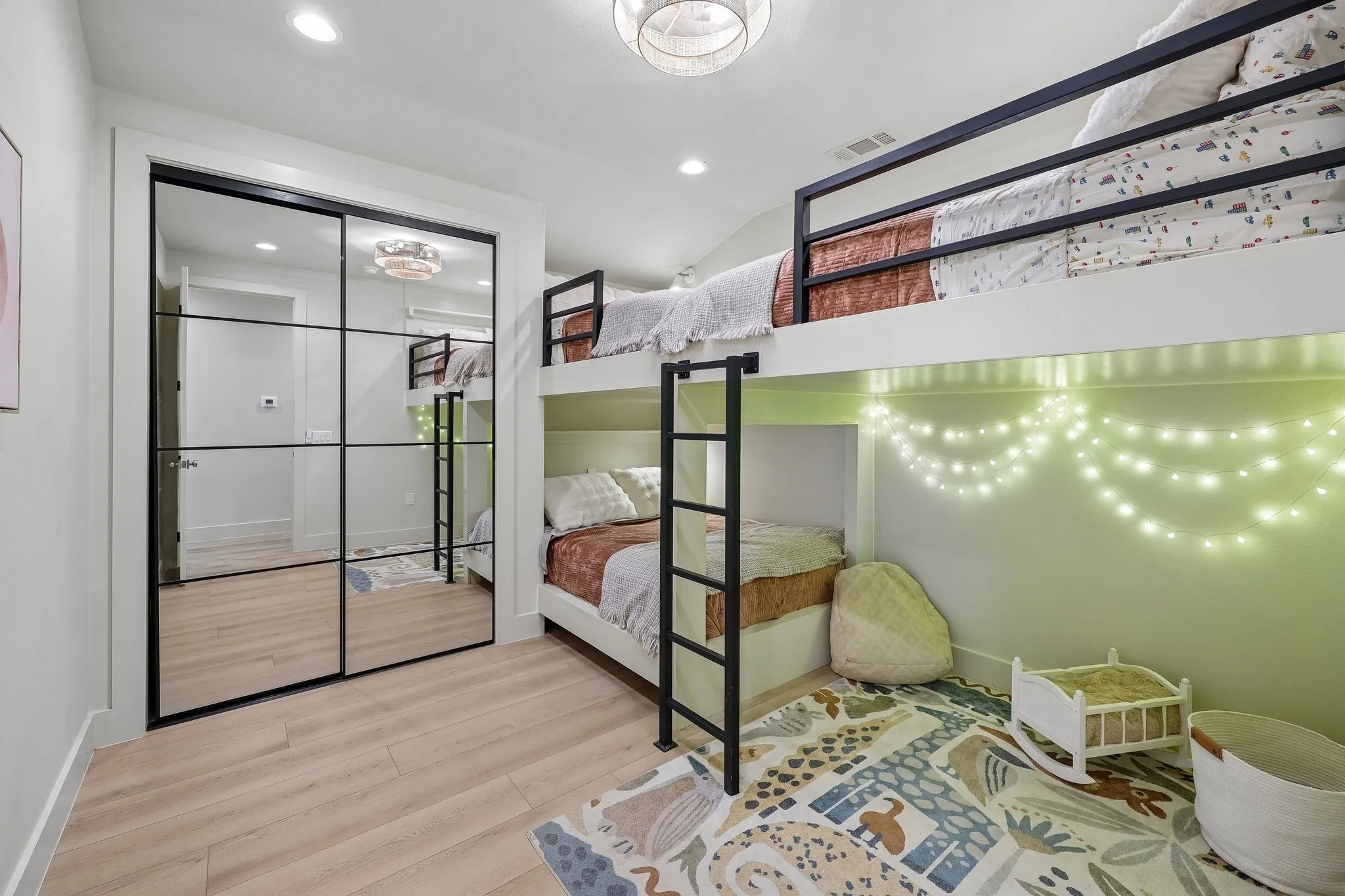 A custom-built bunk features two full beds on the upper level and one full bed below,
with a cozy childrens play area tucked beneath the second upper bunk. Every bed
includes its own reading light, charging outlet, and bedside ledge.