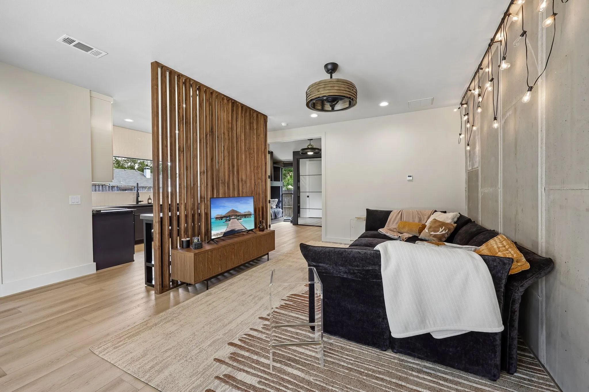 Cozy living room and clever open wall is a design element, not just a dilineator of space.