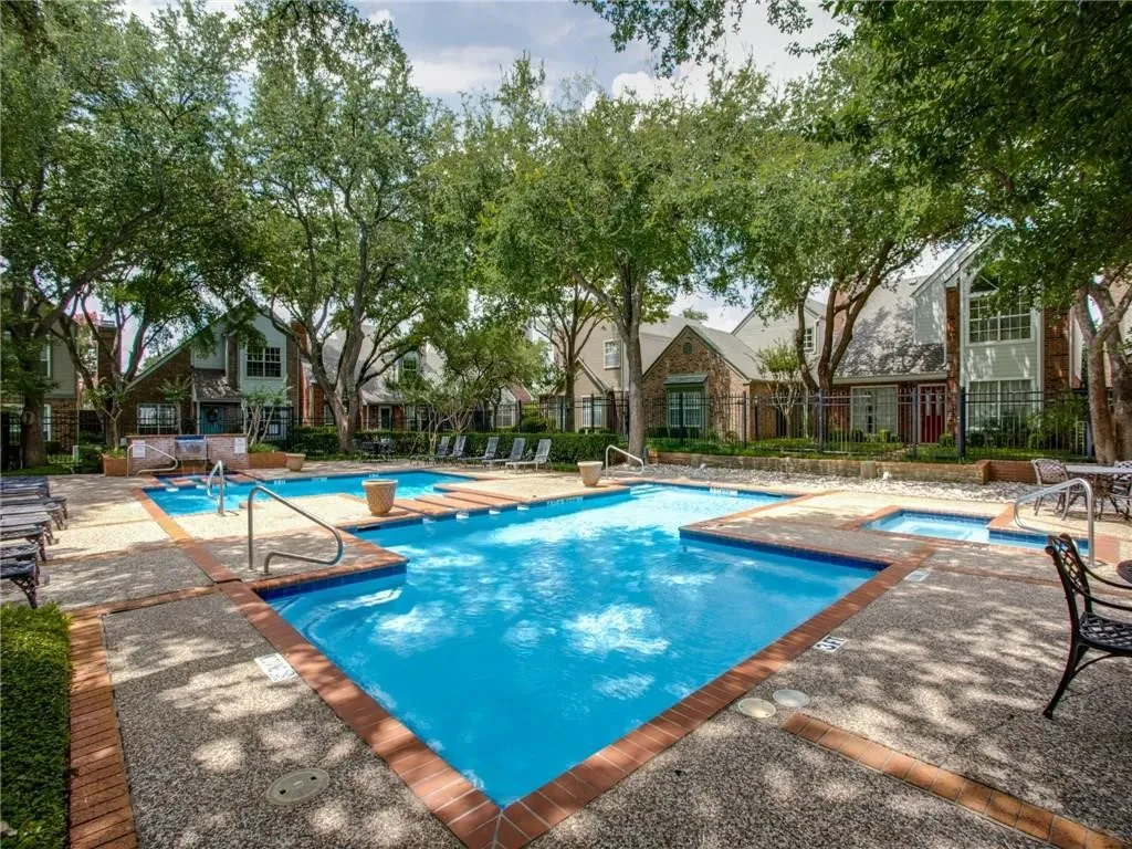 View of pool featuring a hot tub and a patio